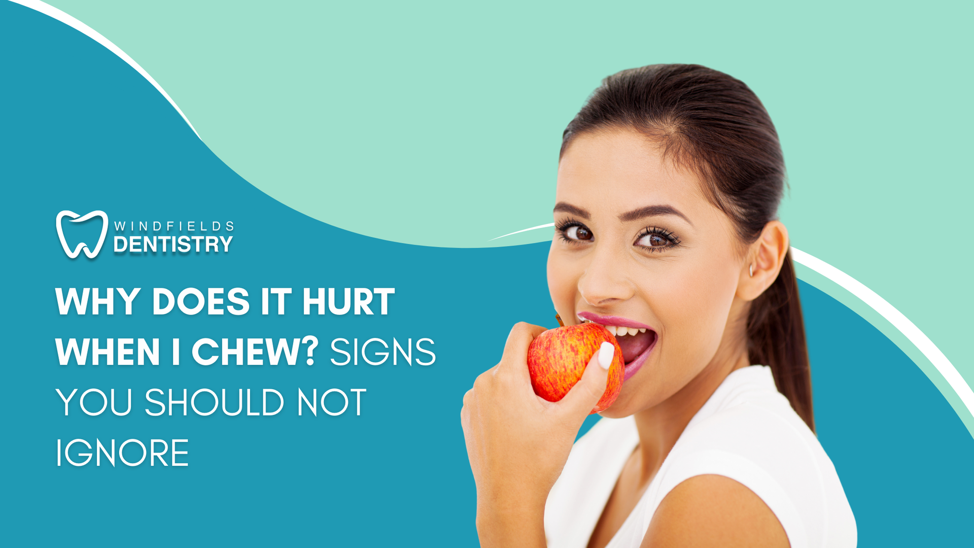 A woman is eating an apple while holding it in her mouth.