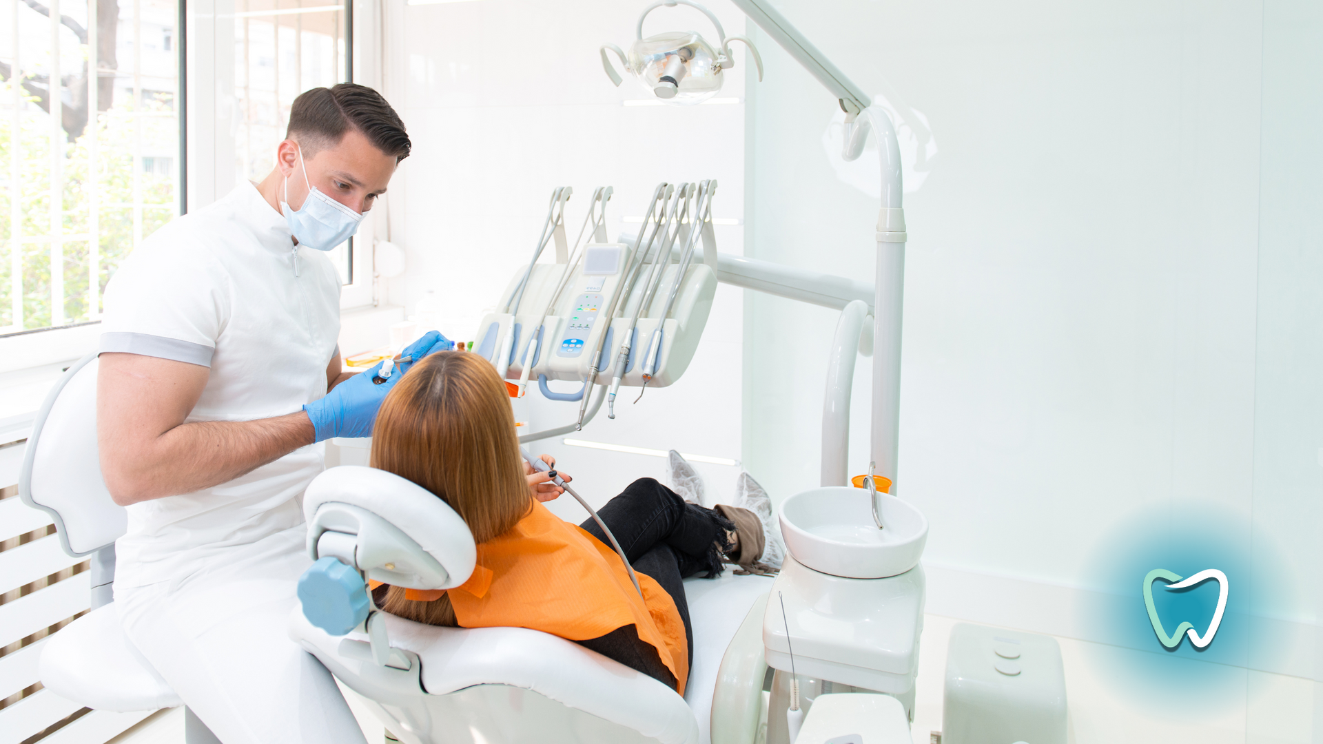 A woman is sitting in a dental chair getting her teeth examined by a dentist.