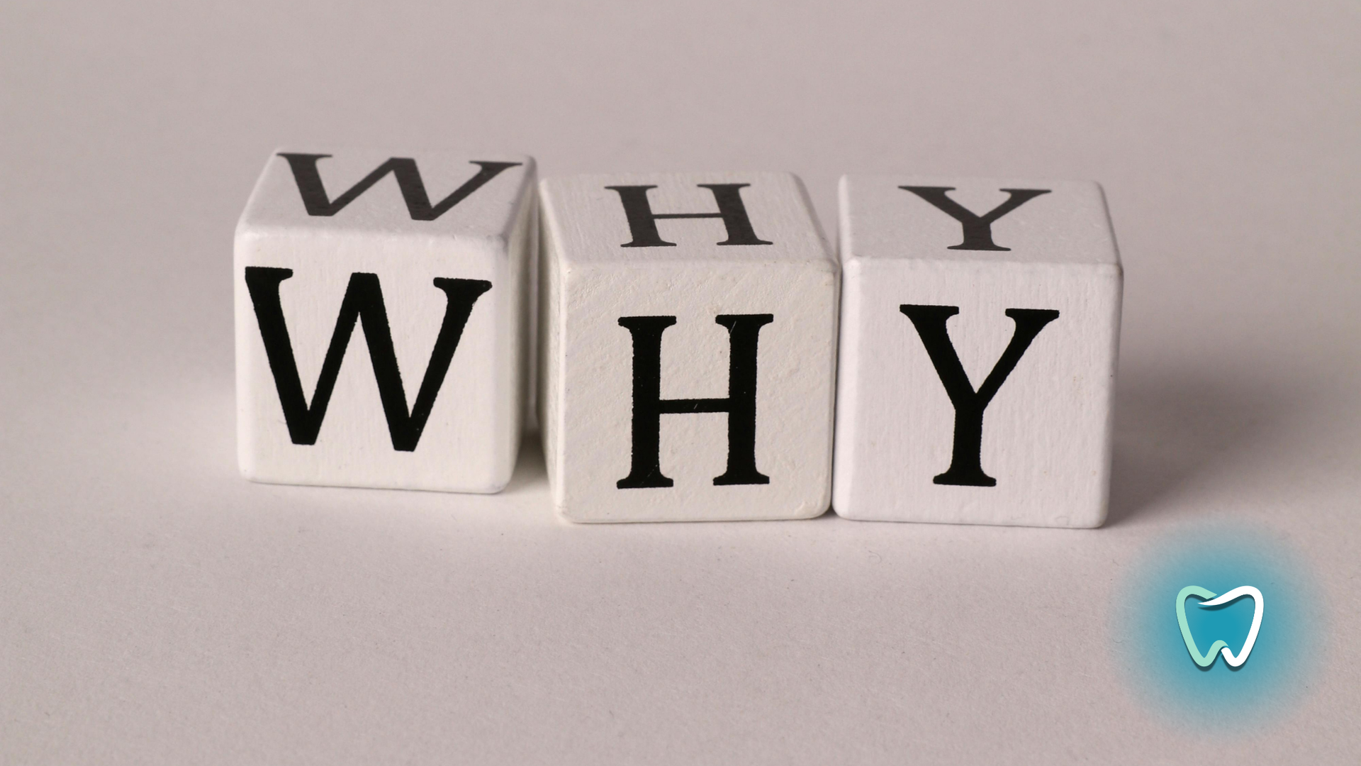 The word why is written on a white block