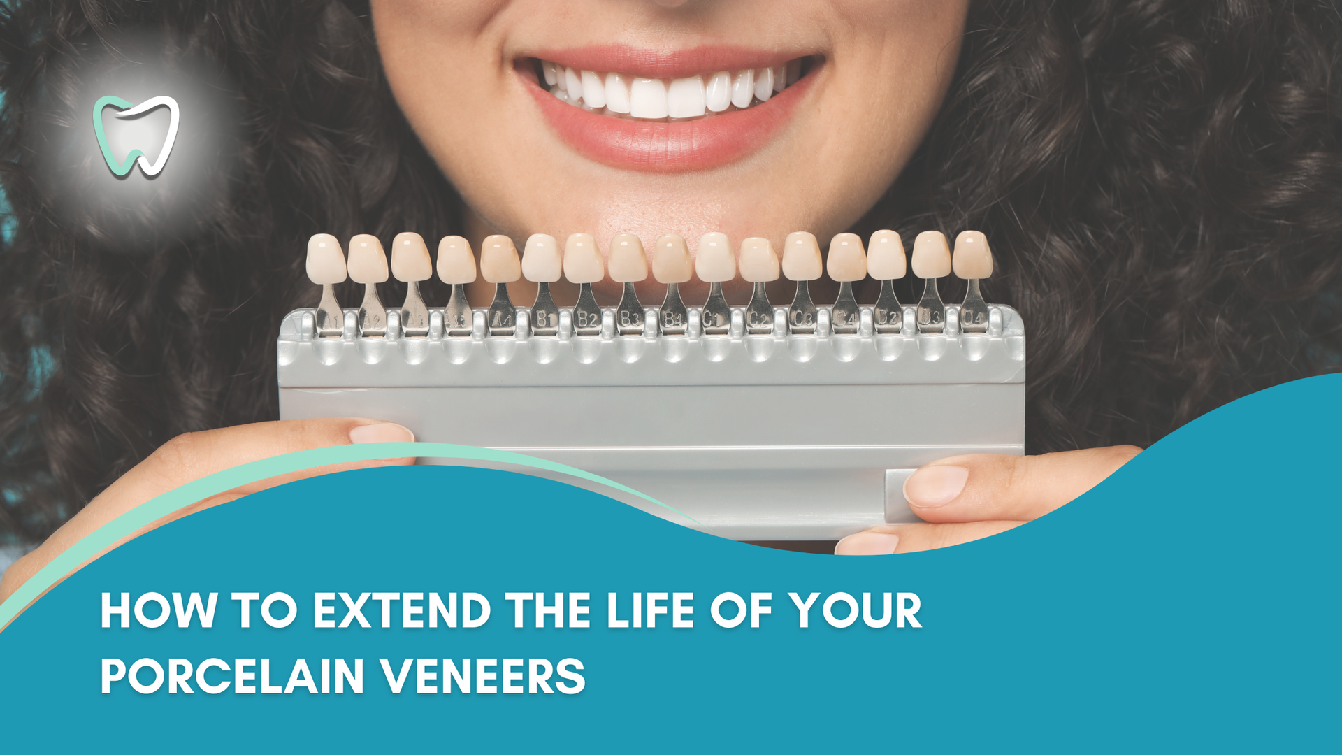 A woman is holding a porcelain veneer in front of her teeth.