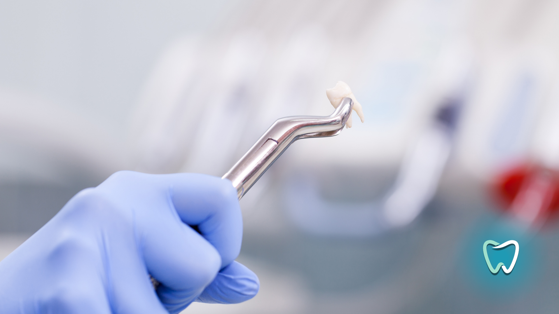 A dentist is holding a dental tool in his hand.