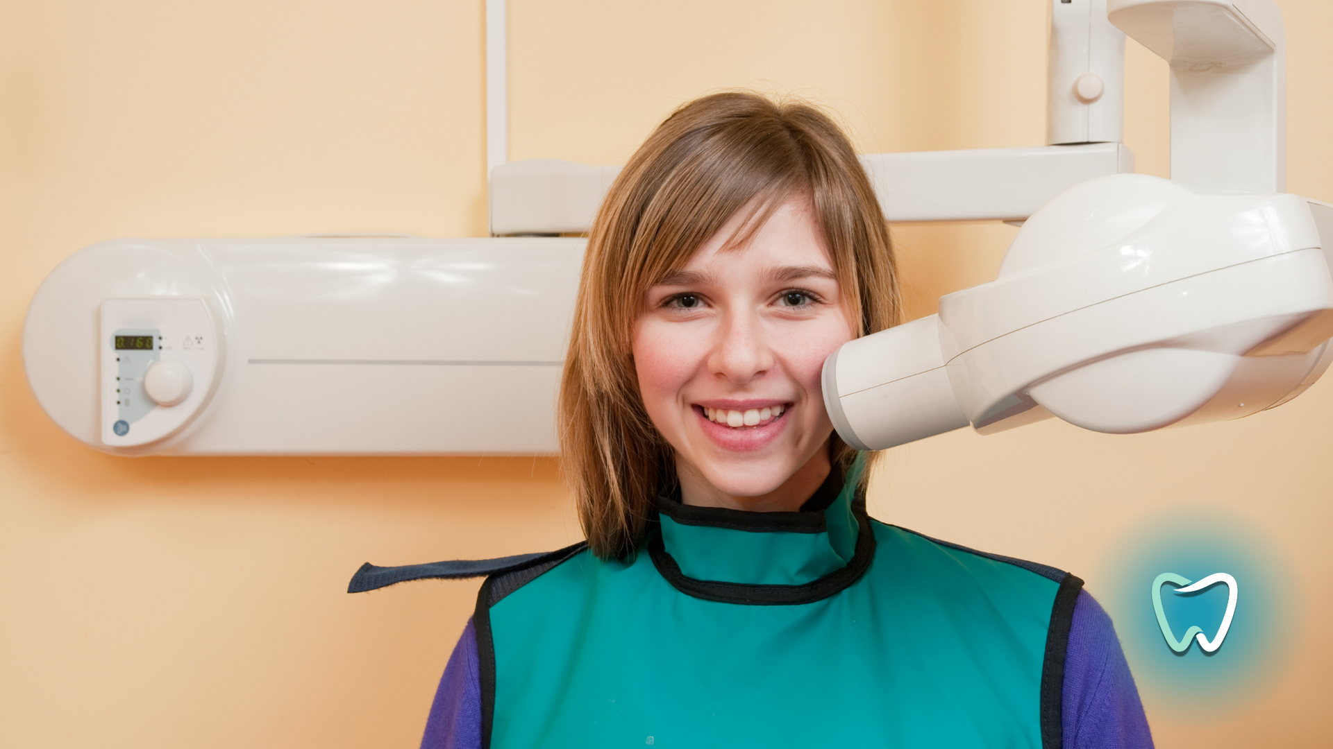 A woman is getting an x-ray of her teeth in a dental office.