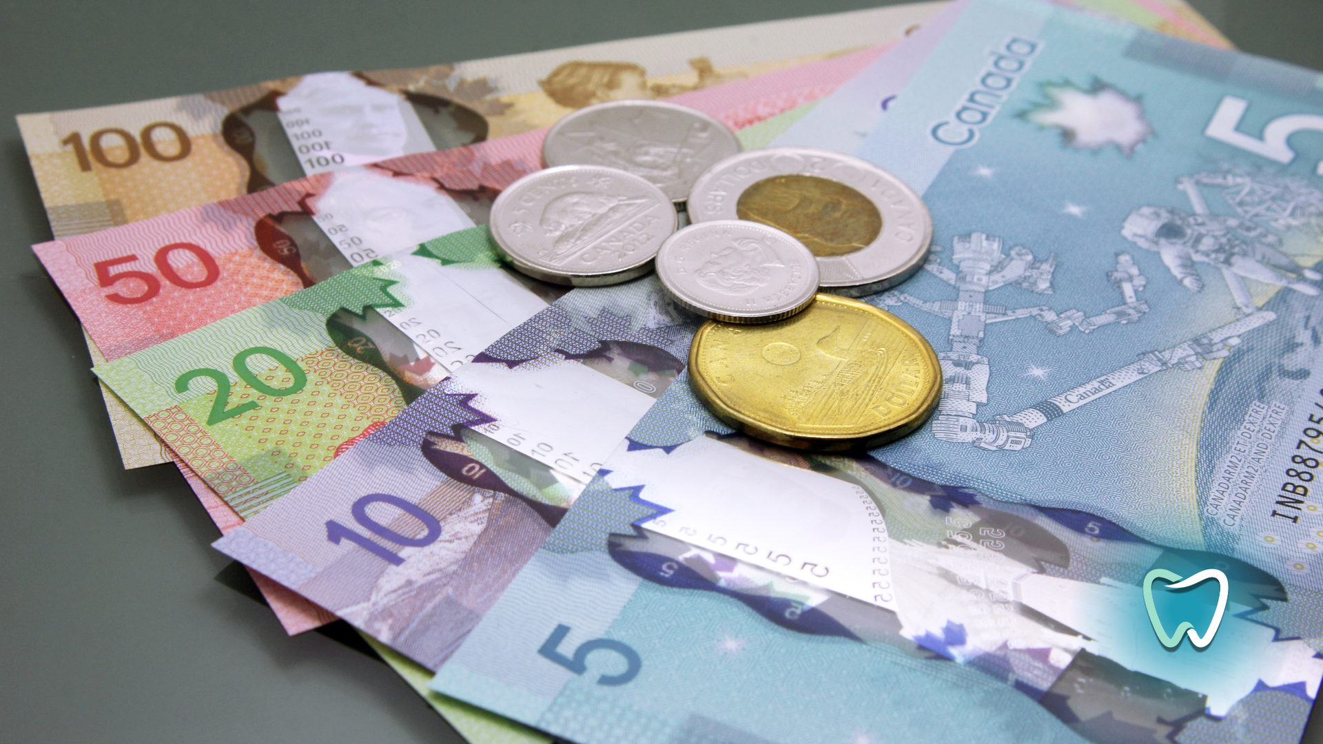 Canadian currency: bills and coins, various denominations, on a surface.
