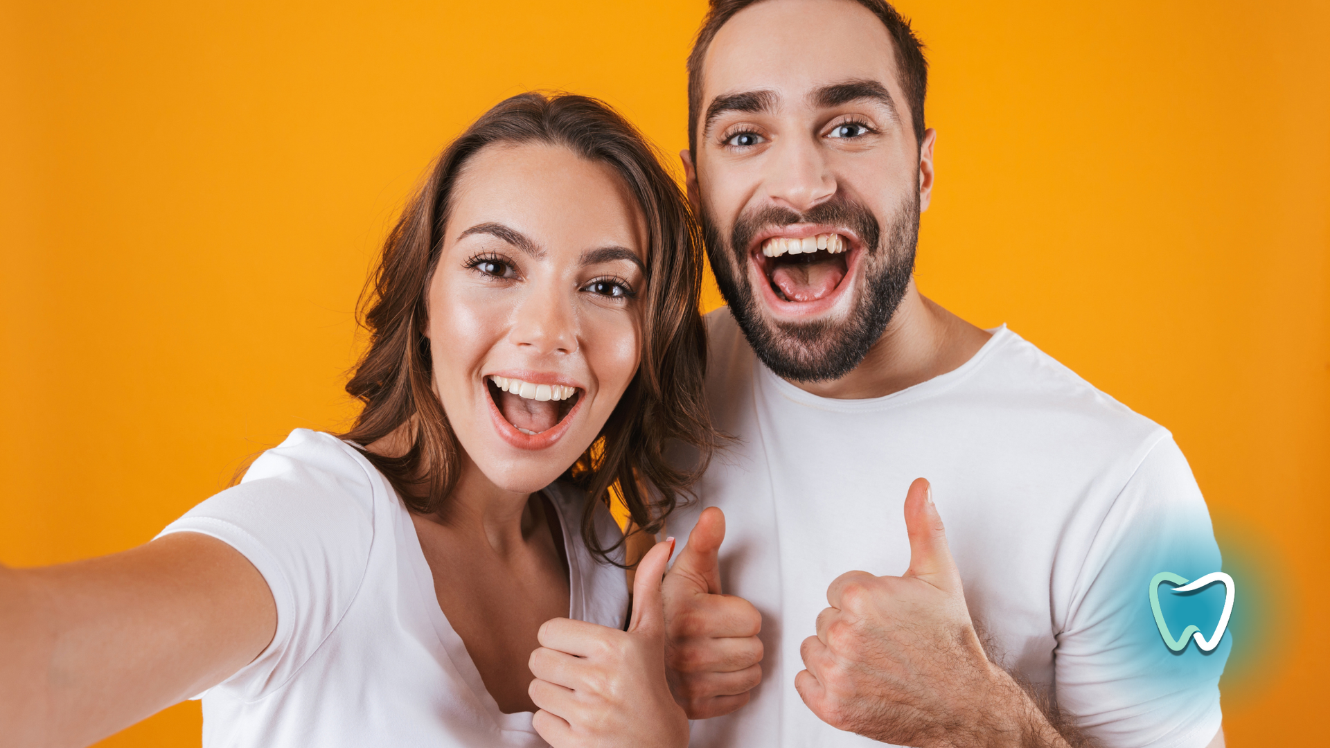 Smiling couple giving thumbs up; yellow background, graphic of a tooth.