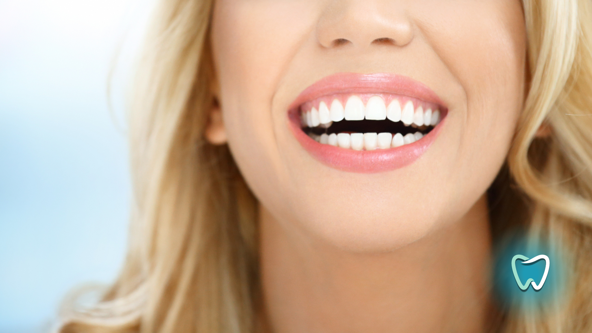 Woman with blonde hair smiling, showing white teeth, with a blue tooth graphic.