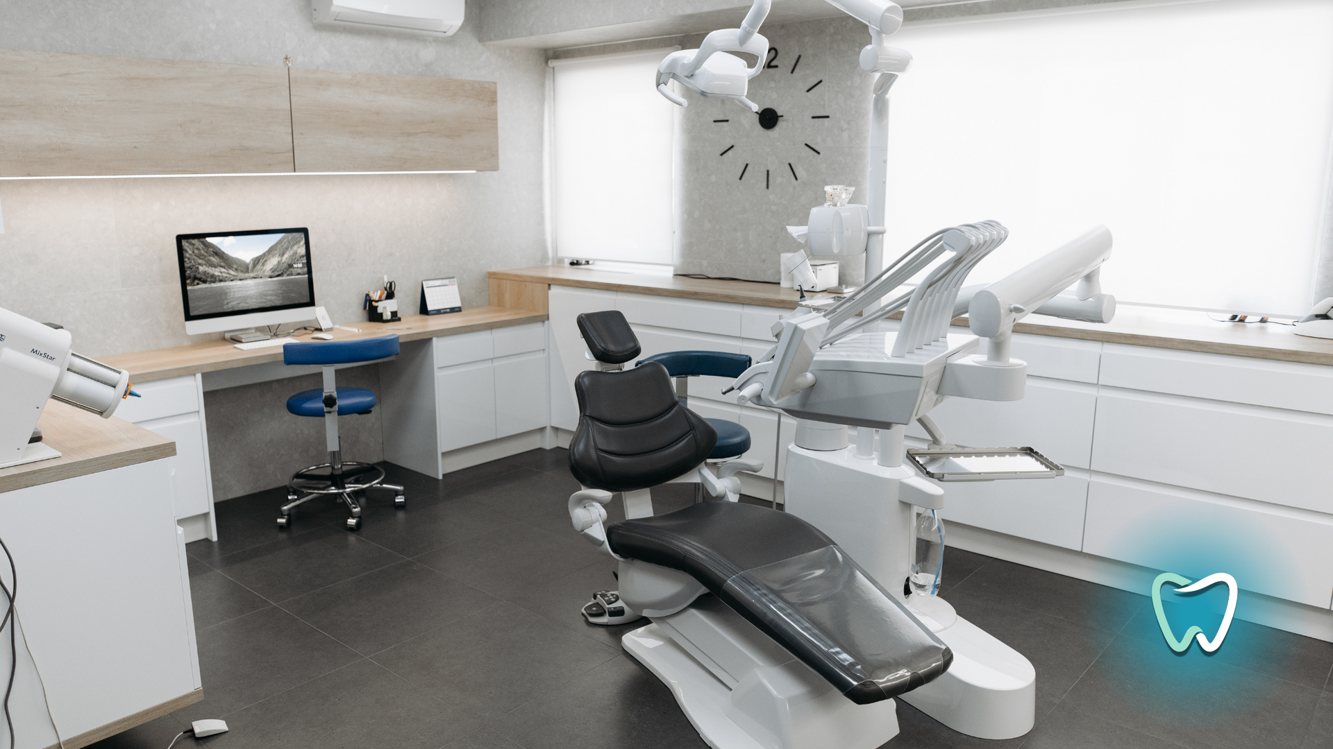 A dental office with a dental chair and a clock on the wall.