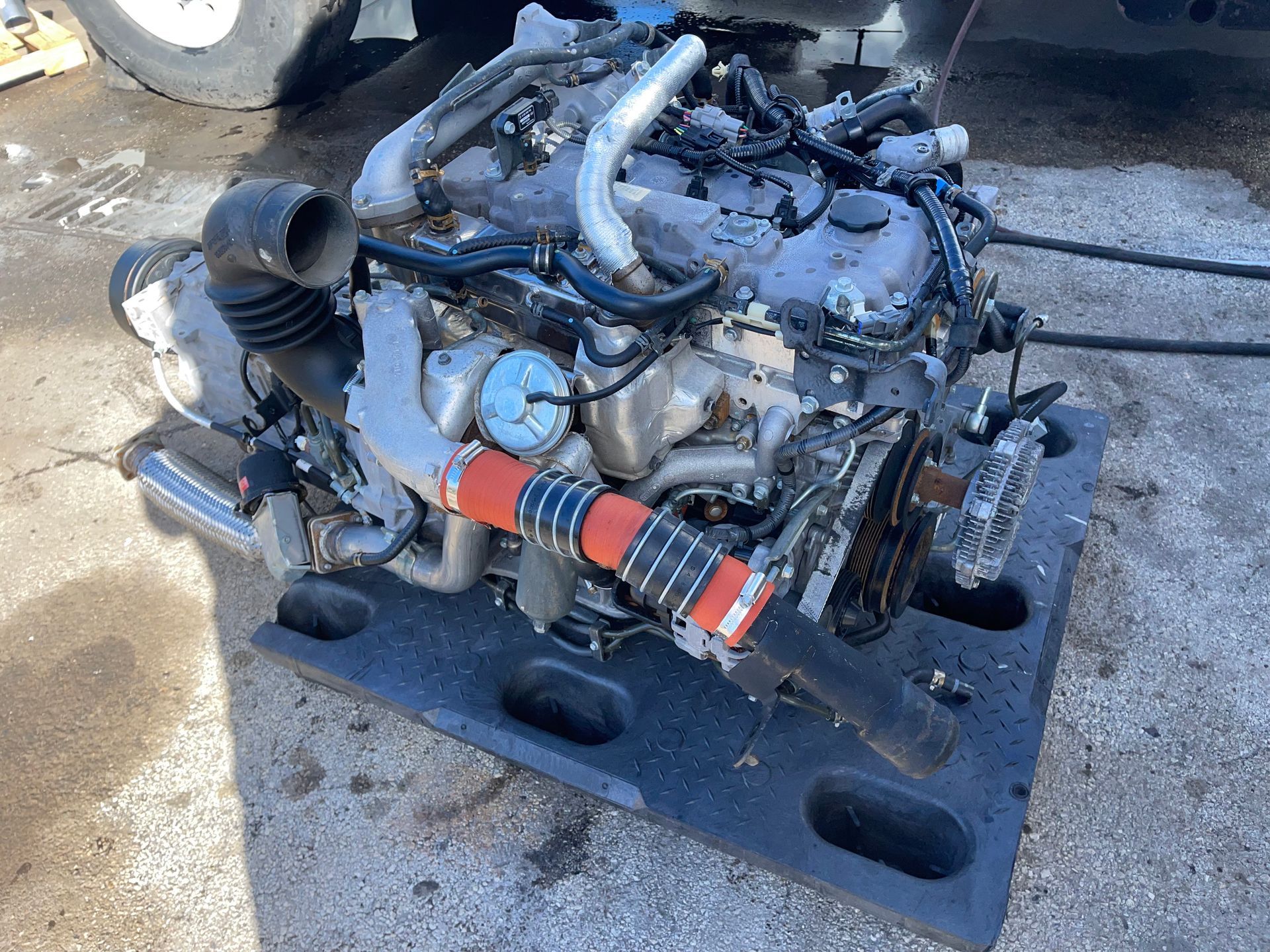 A diesel engine is sitting on top of a plastic tray.