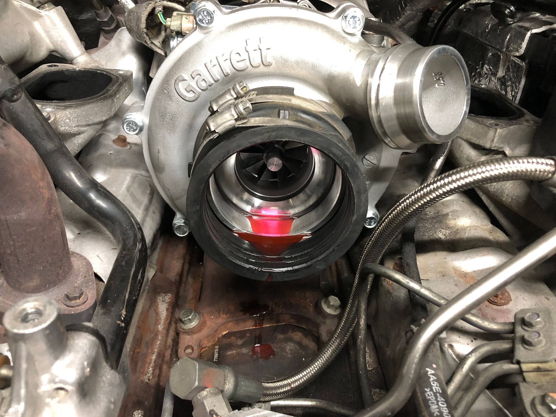 A turbocharger is sitting inside of a car engine.