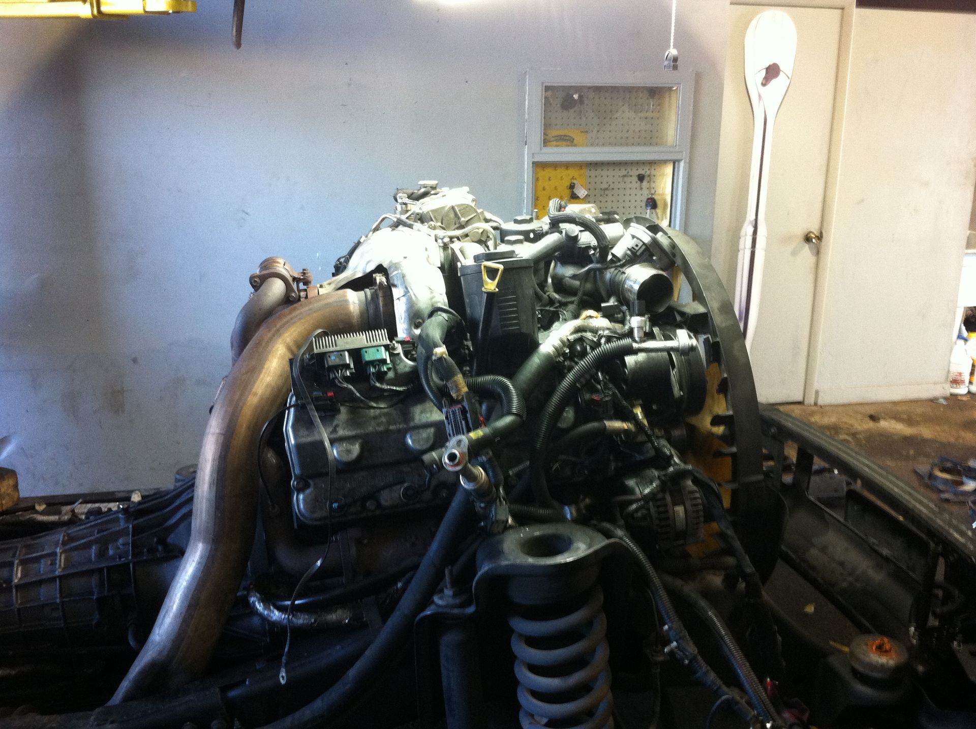 A large engine is sitting on a table in a garage