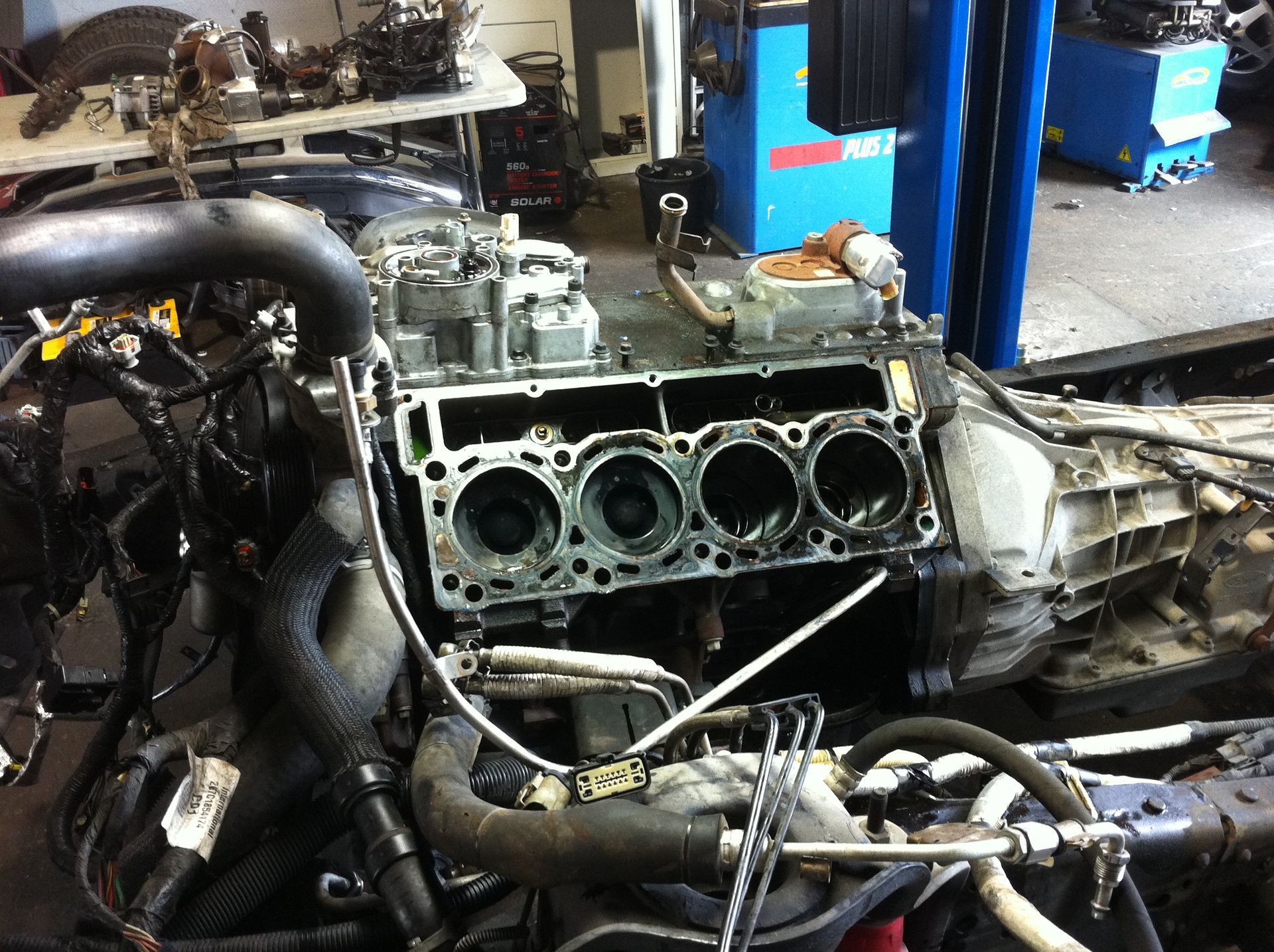 A car engine is being worked on in a garage