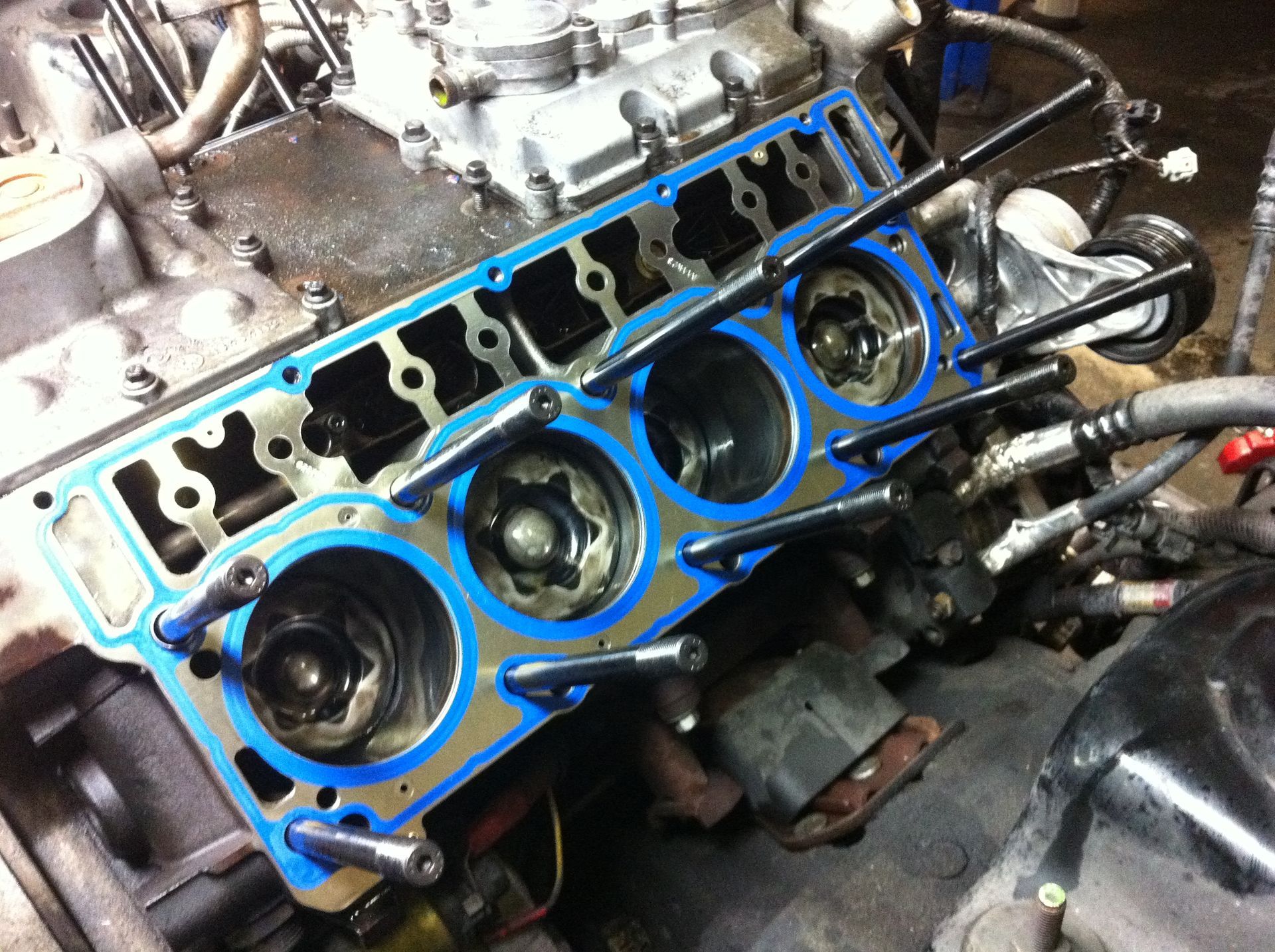 A close up of a car engine with blue gaskets