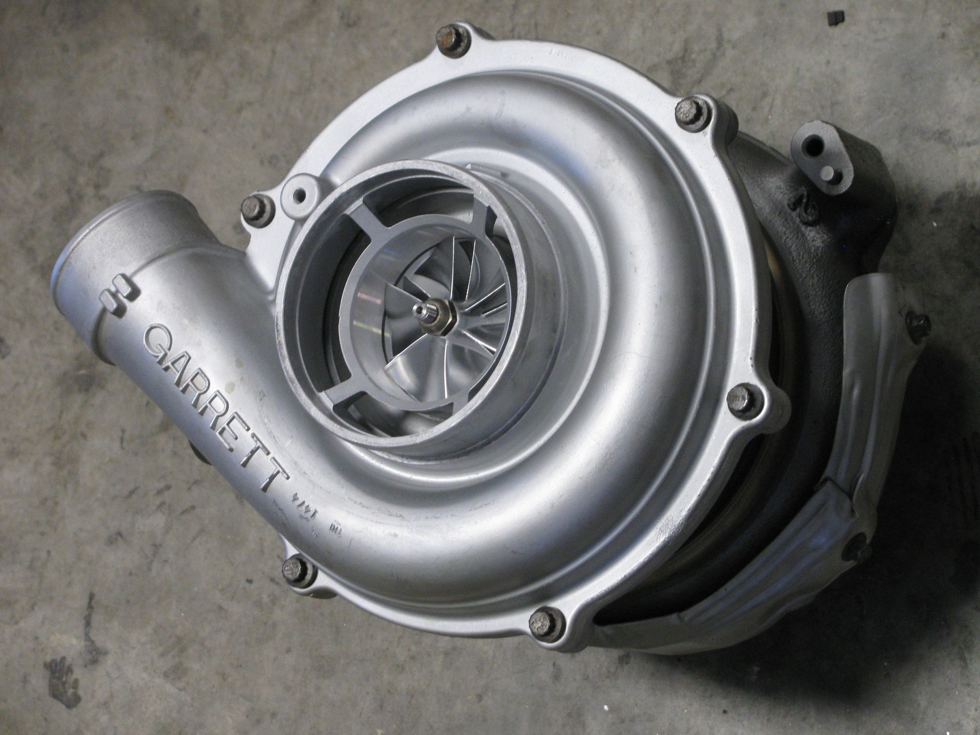 A garrett turbocharger is sitting on the ground