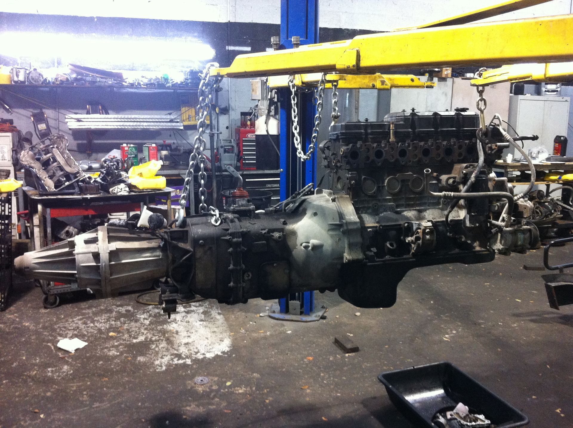 A large engine is being worked on in a garage