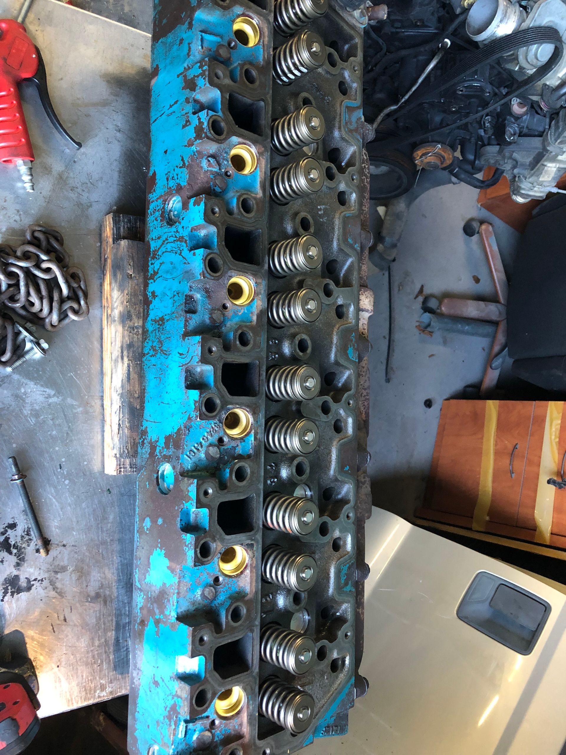 A blue engine head is sitting on top of a table.