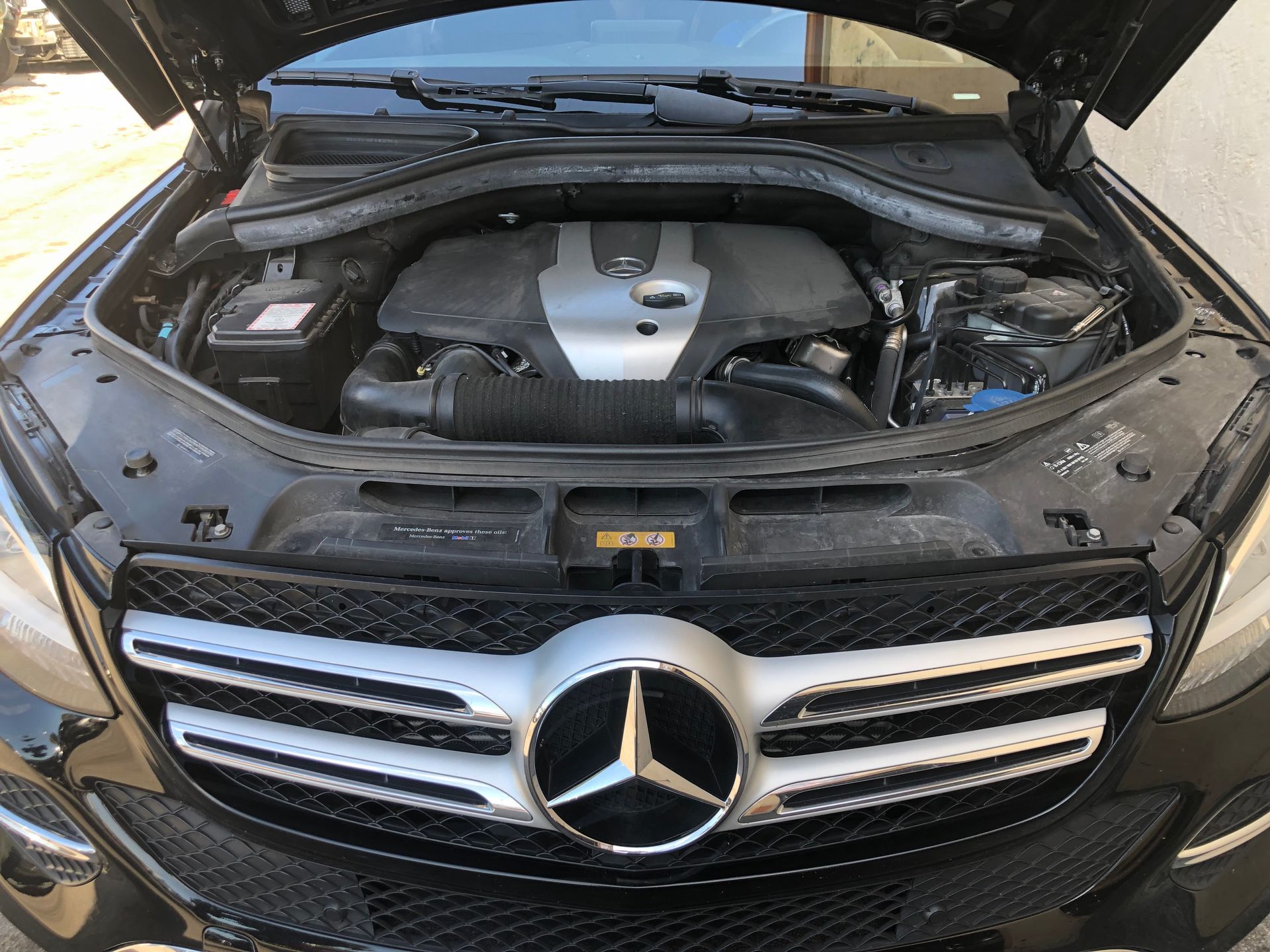 The engine of a mercedes benz gle 450 is shown with the hood open.