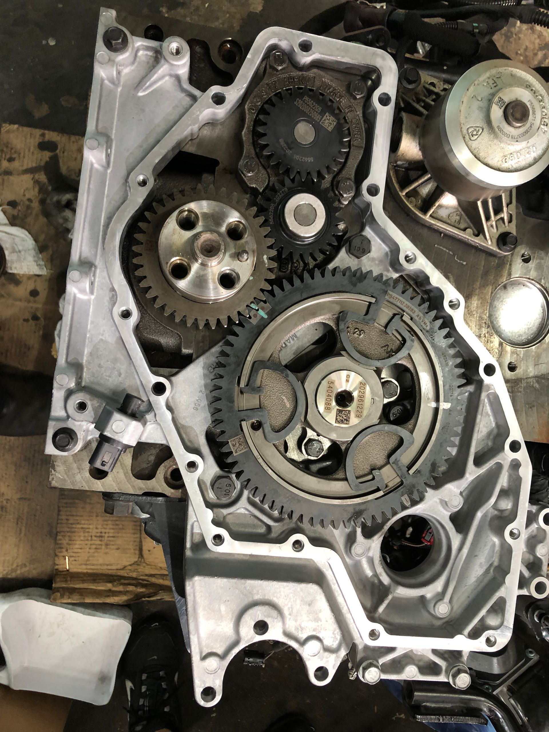 A close up of a motorcycle engine with gears on it.