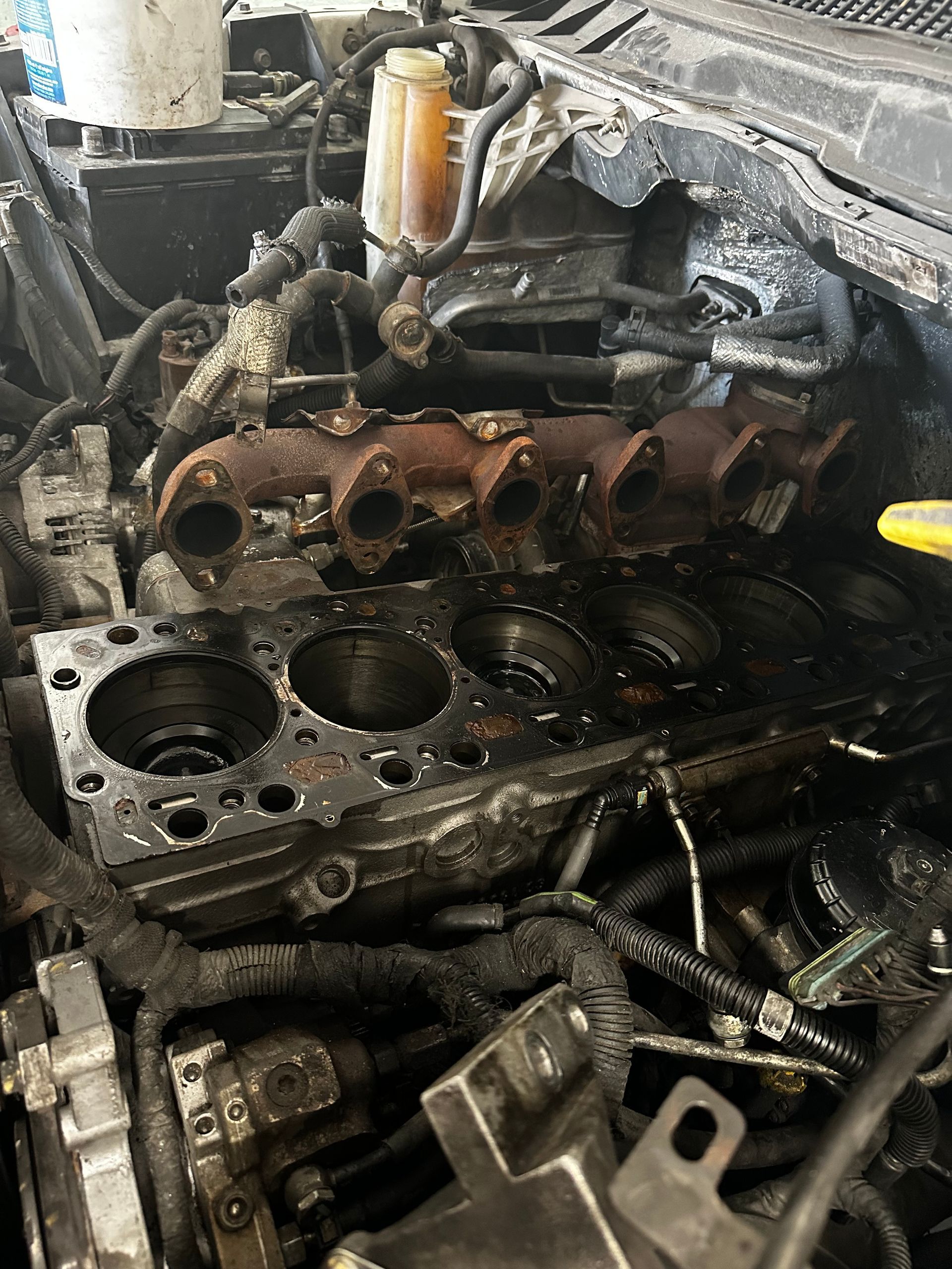 A close up of a car engine that is being worked on