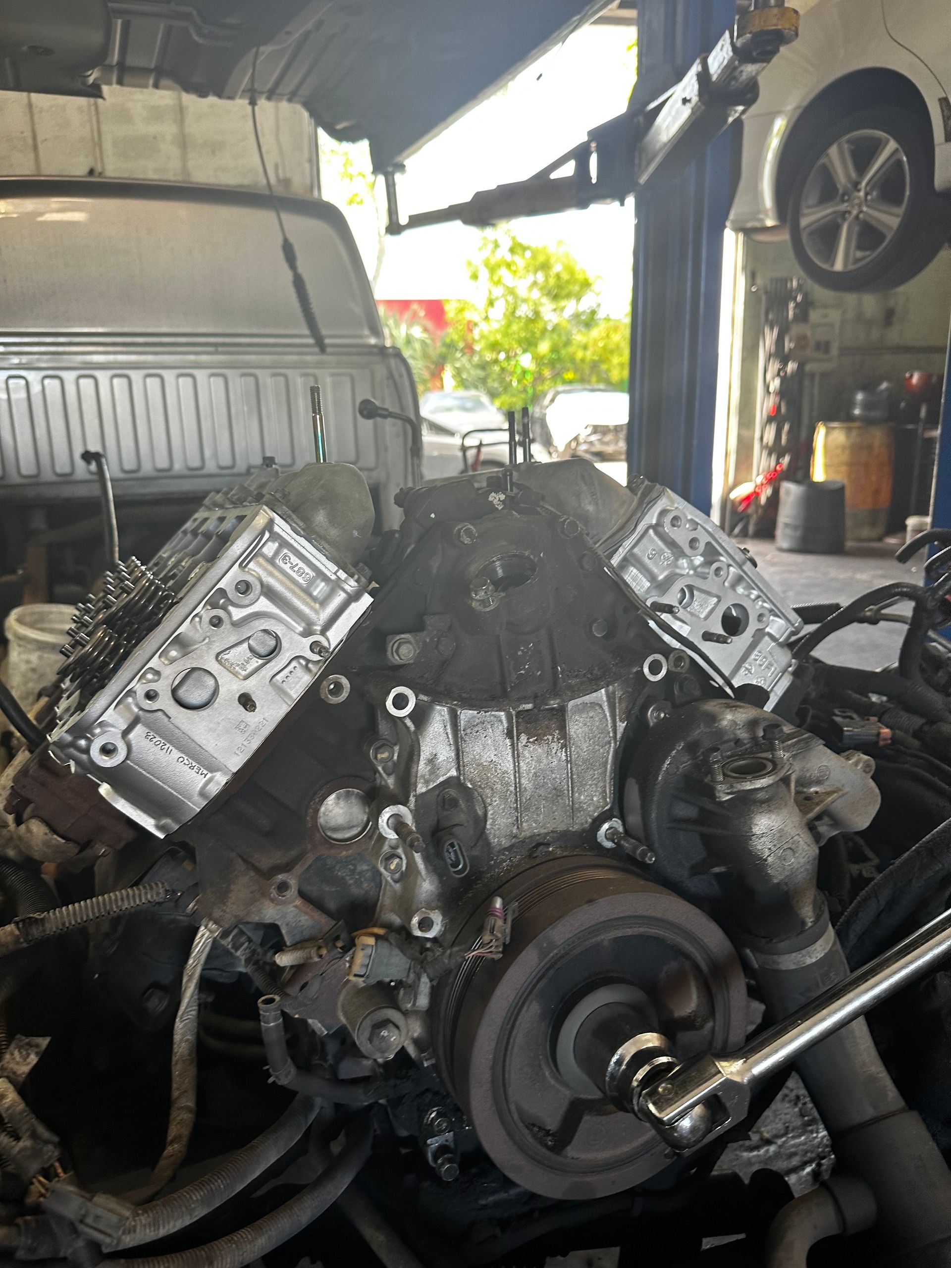 A car engine is being worked on in a garage.