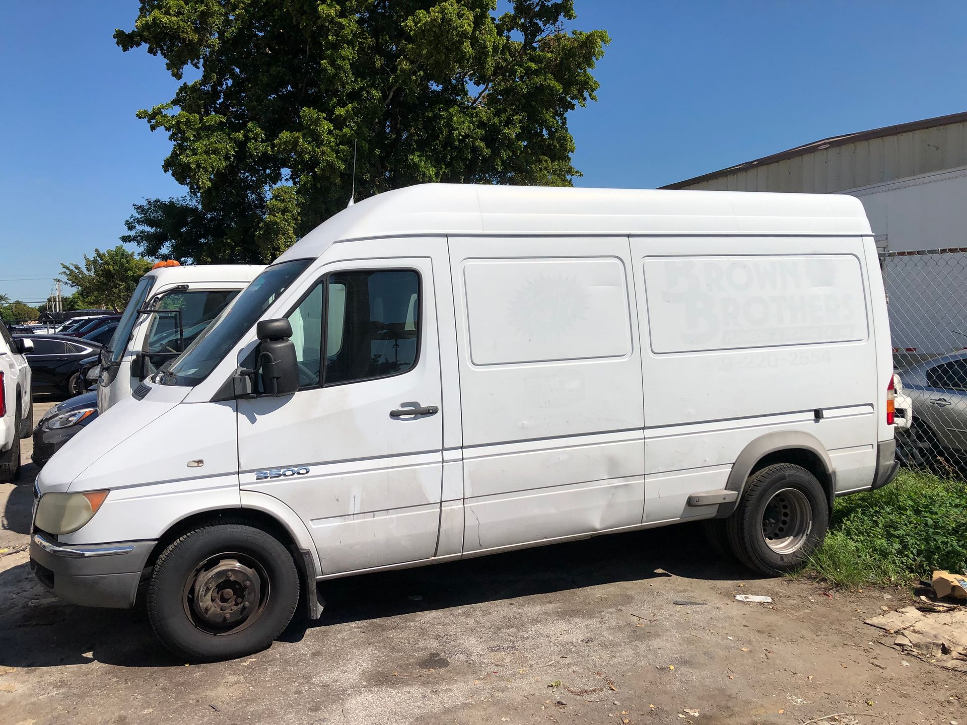 A white van is parked in a parking lot.