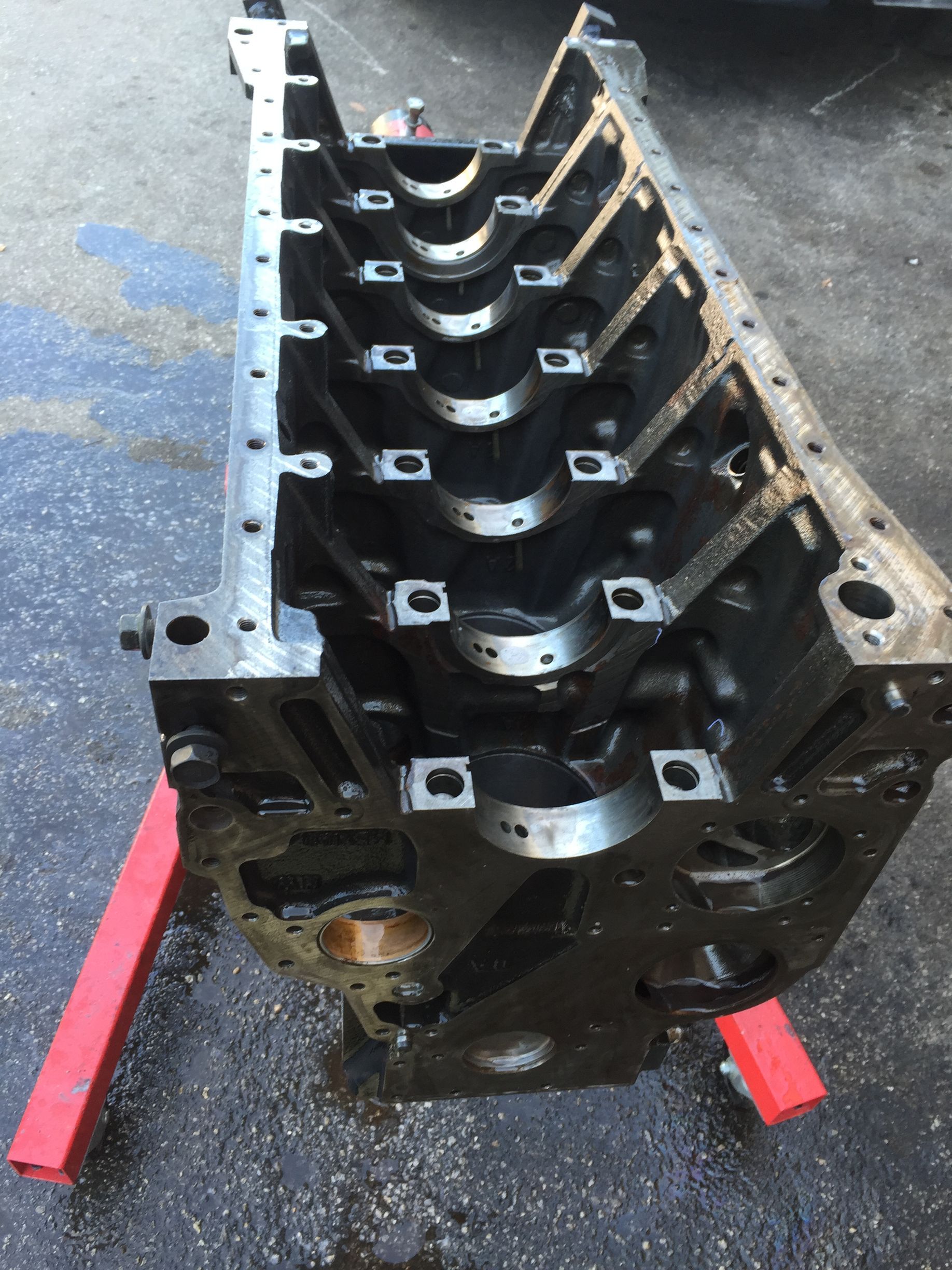 An engine block is sitting on a red stand