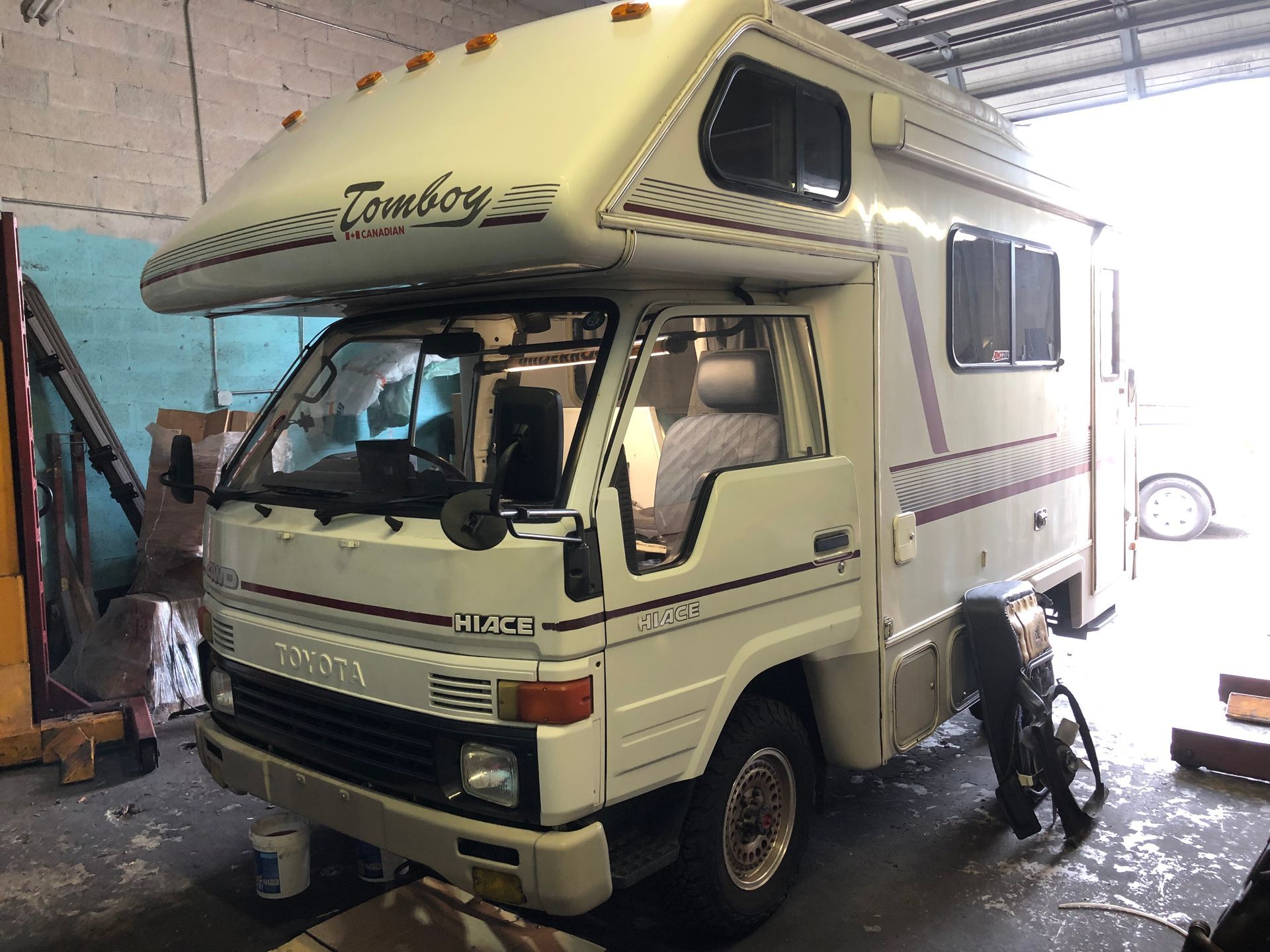 A white rv is parked in a garage.