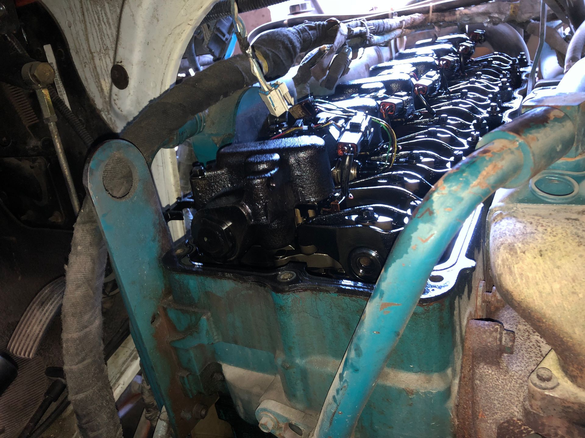 A blue and black engine with a hose attached to it