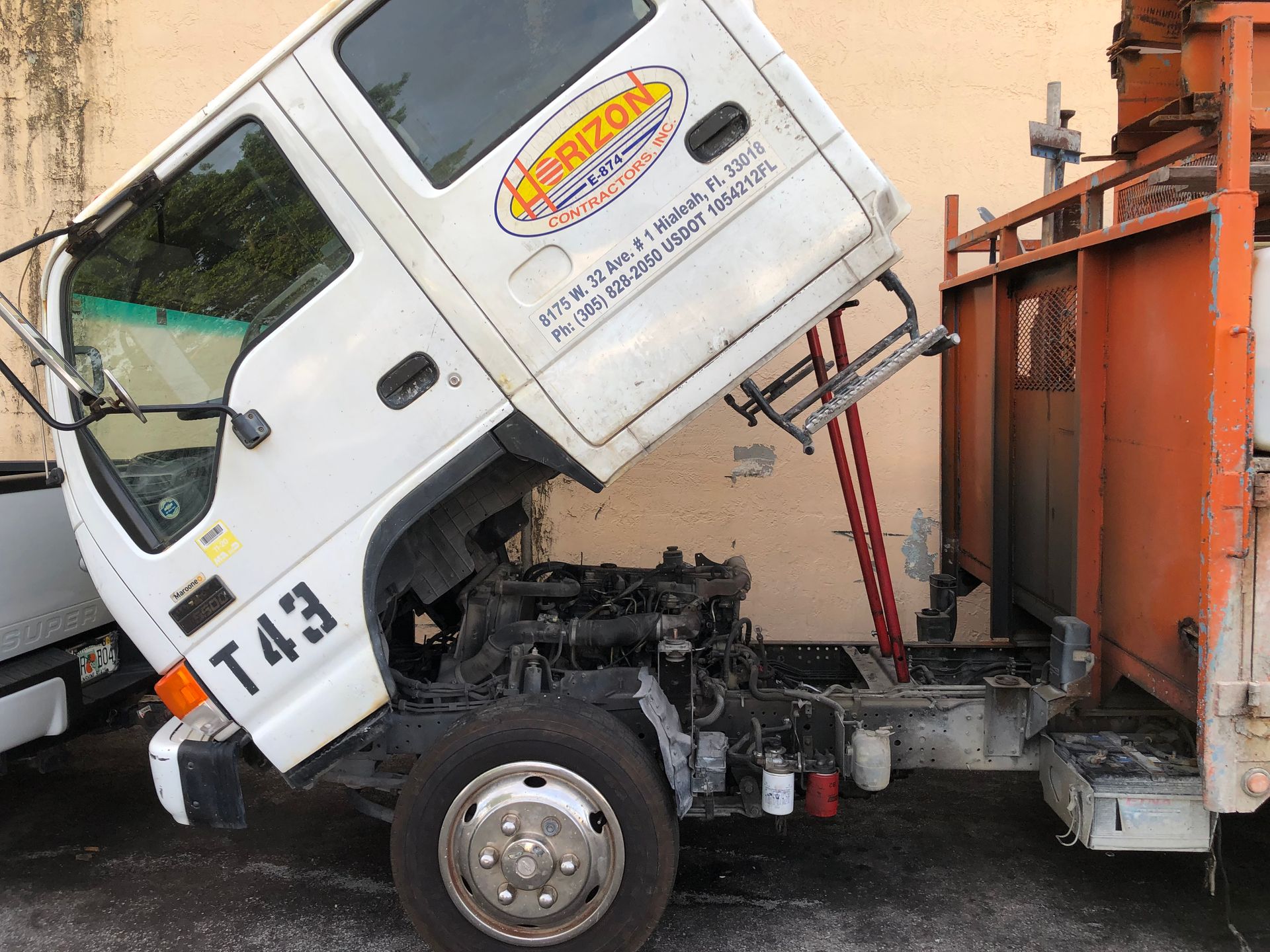 A white truck with the number t43 on the side of it