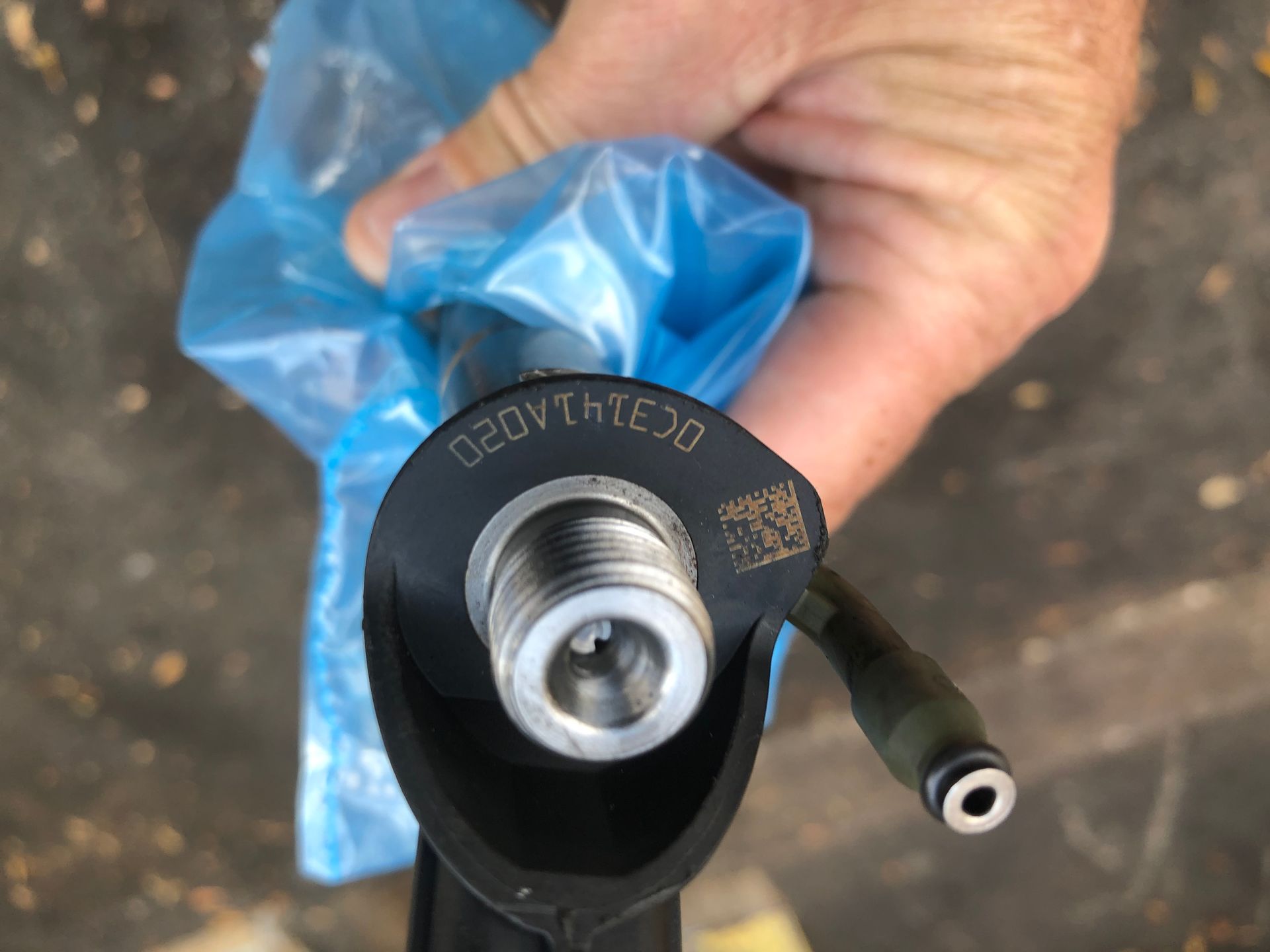 A close up of a person holding a piece of metal