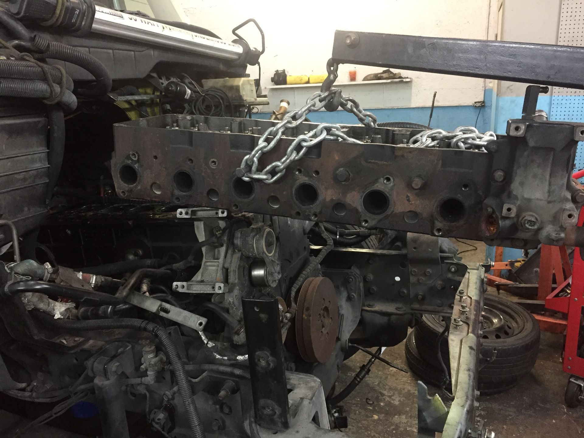 A car engine is being dismantled in a garage