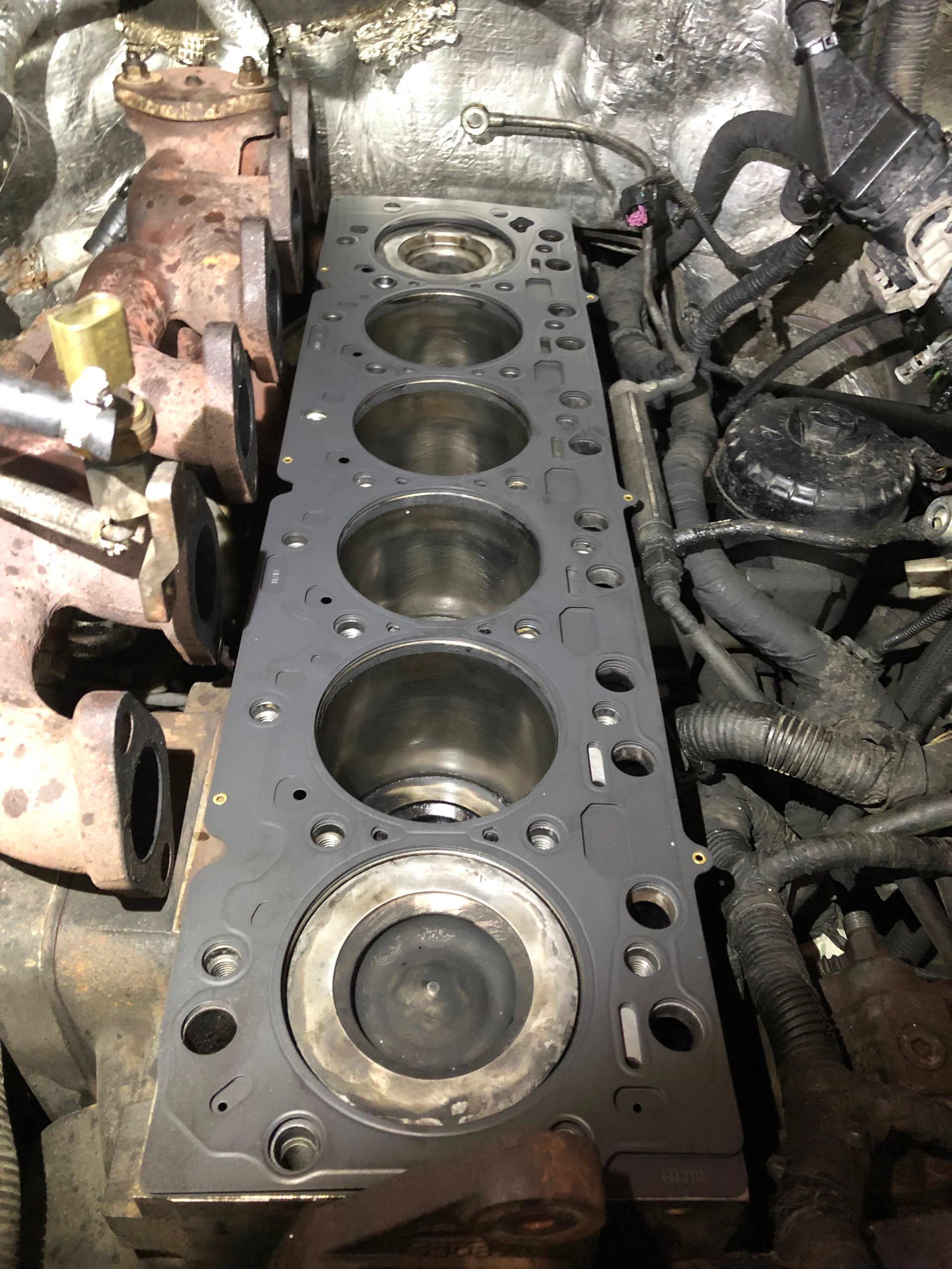 A close up of a cylinder head of a car engine.