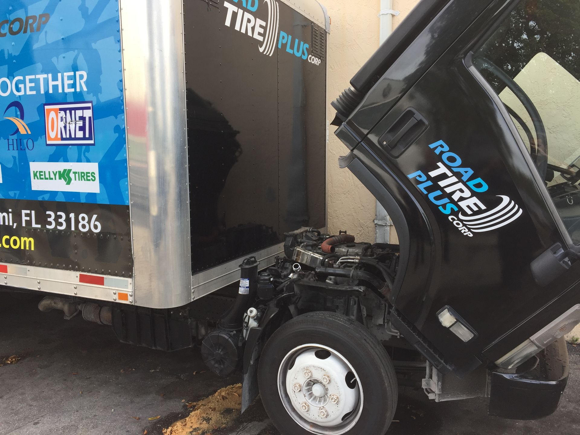 A road tire plus truck with its hood up