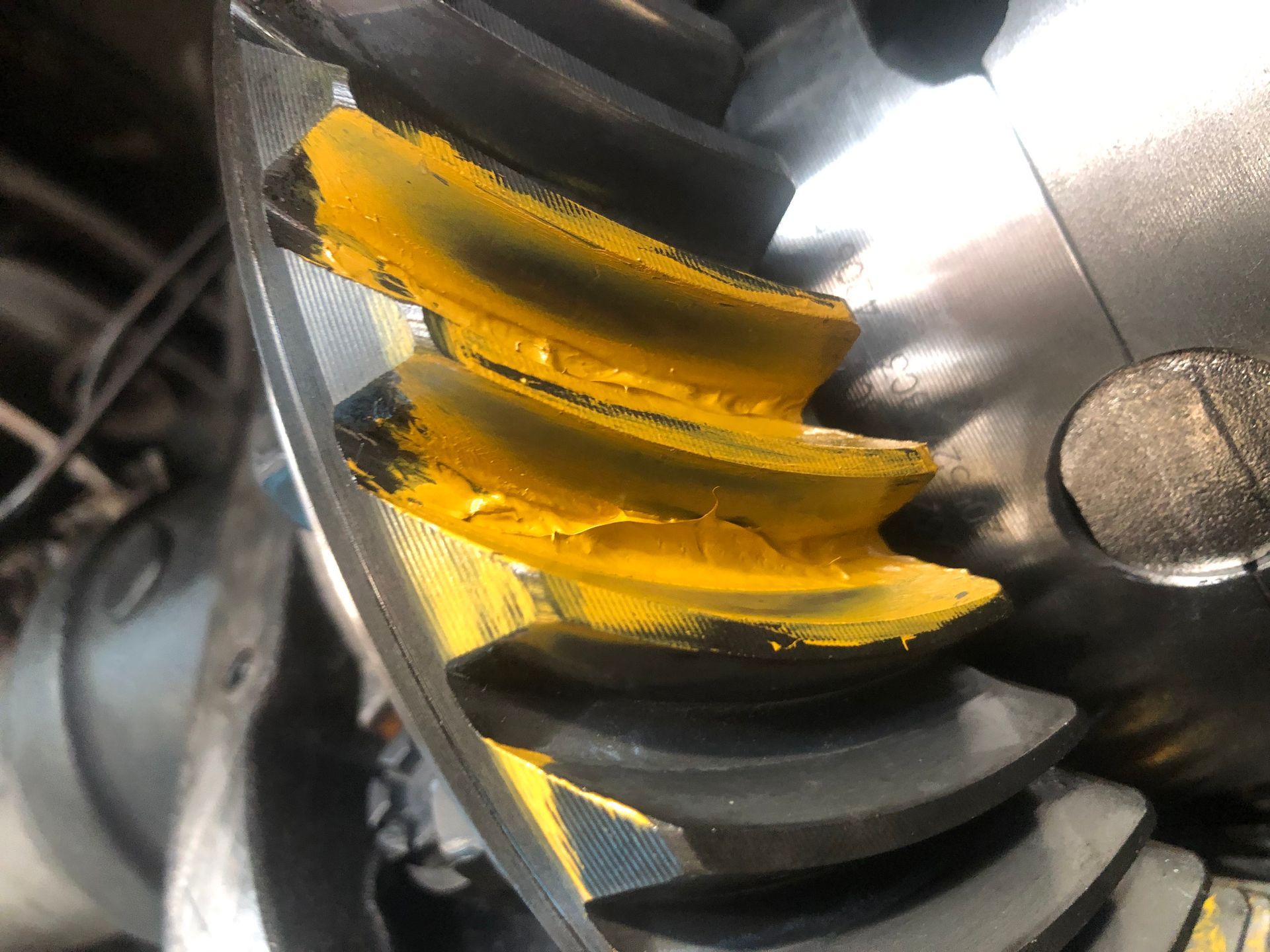 A close up of a gear with yellow grease on it