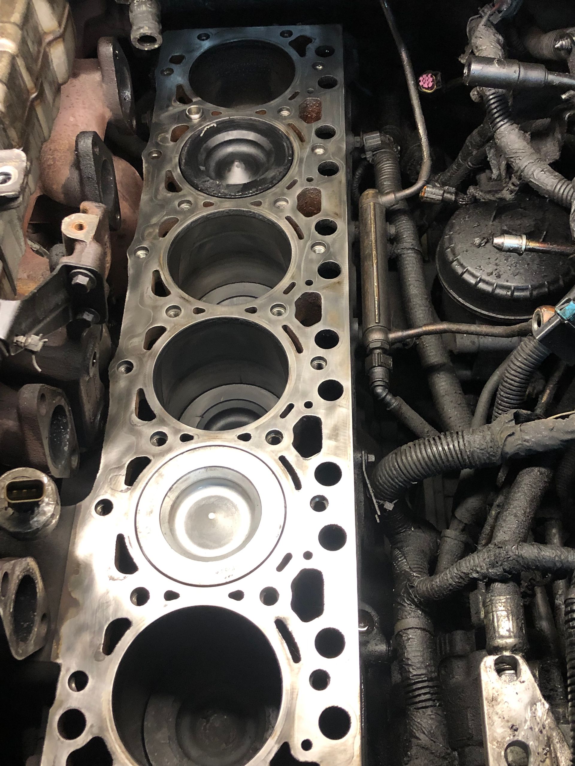 A close up of a cylinder block in a car engine.