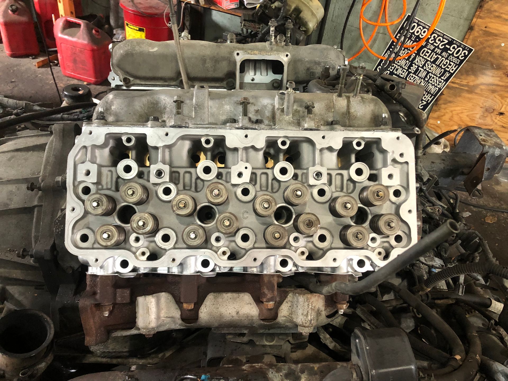 A close up of a car engine in a garage.