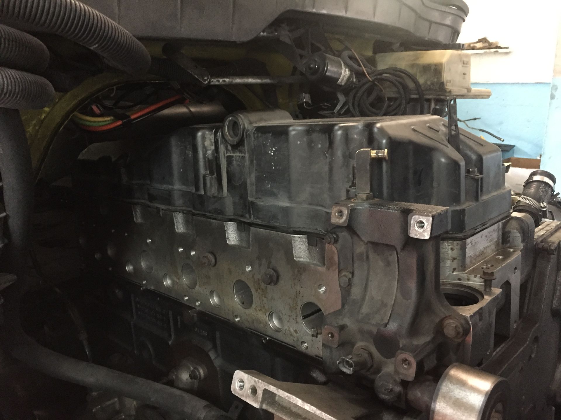 A close up of a tractor engine in a garage.