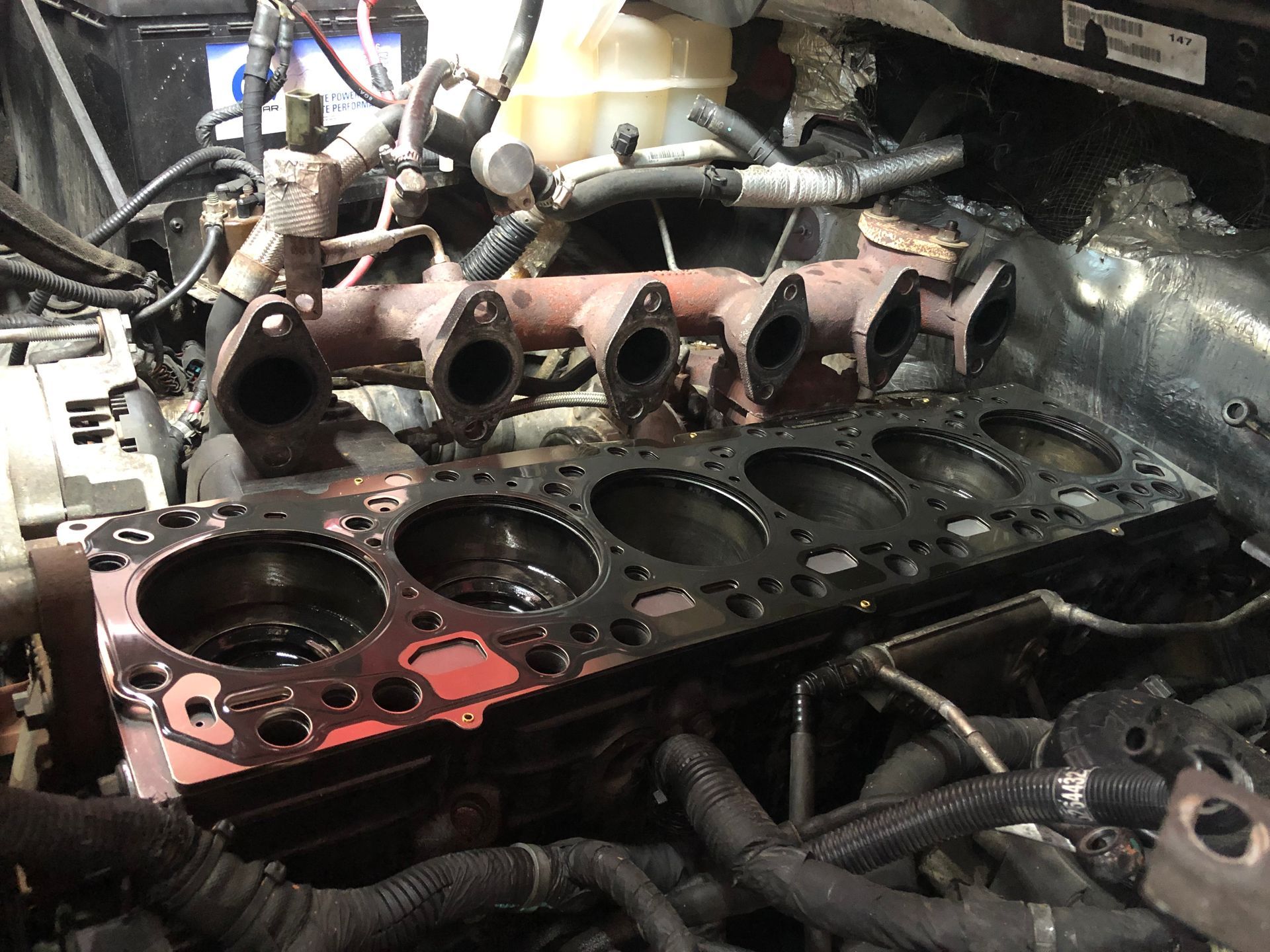 A close up of a car engine with the cylinder head removed