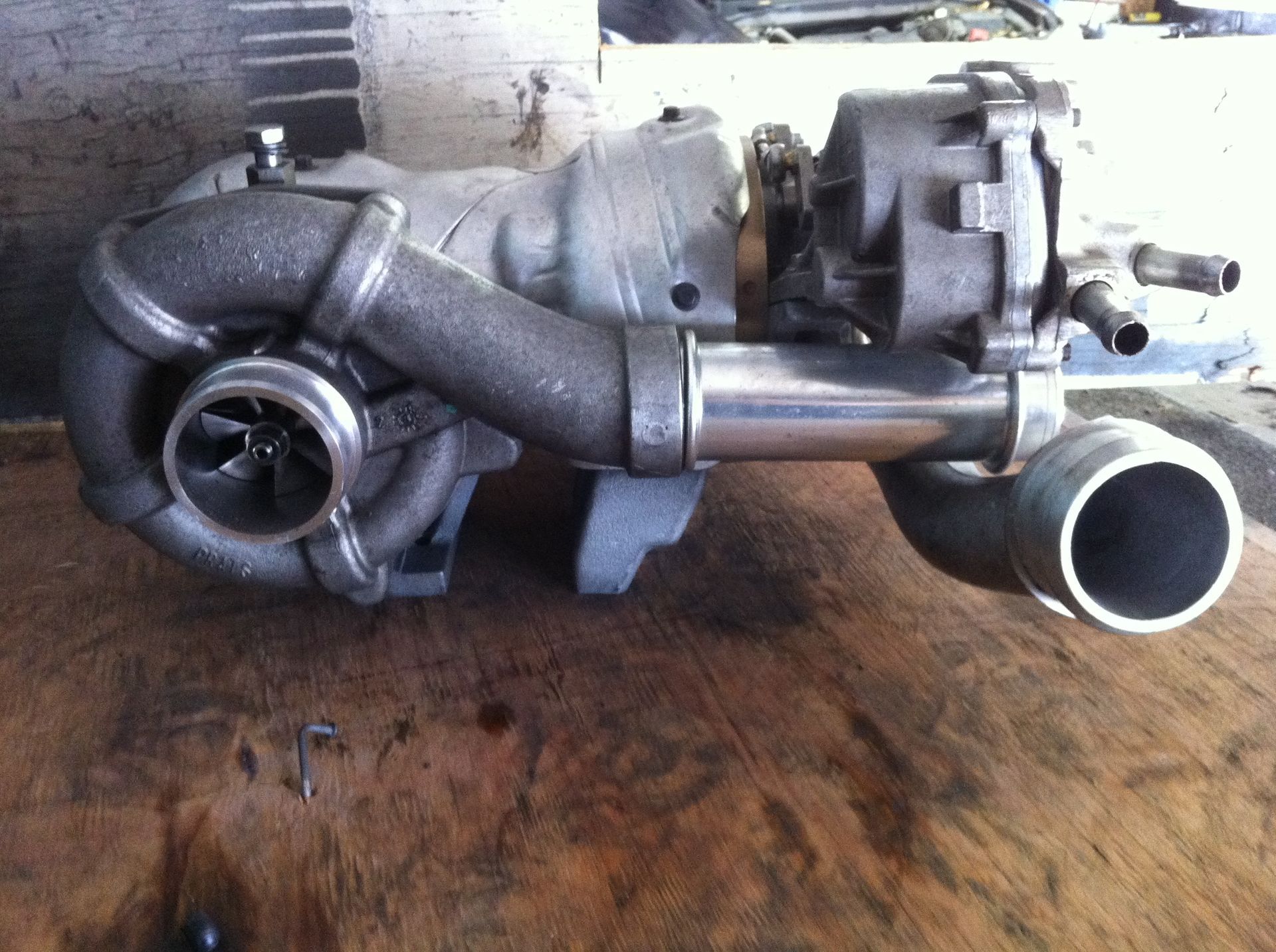 A turbocharger is sitting on a wooden table