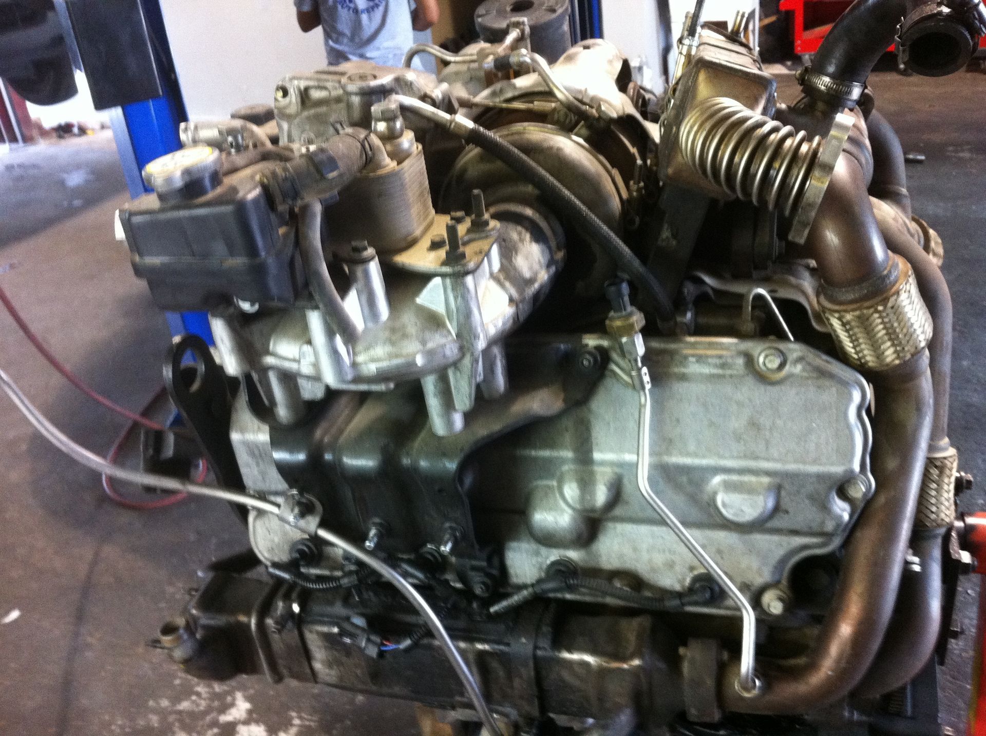 A close up of a motorcycle engine in a garage