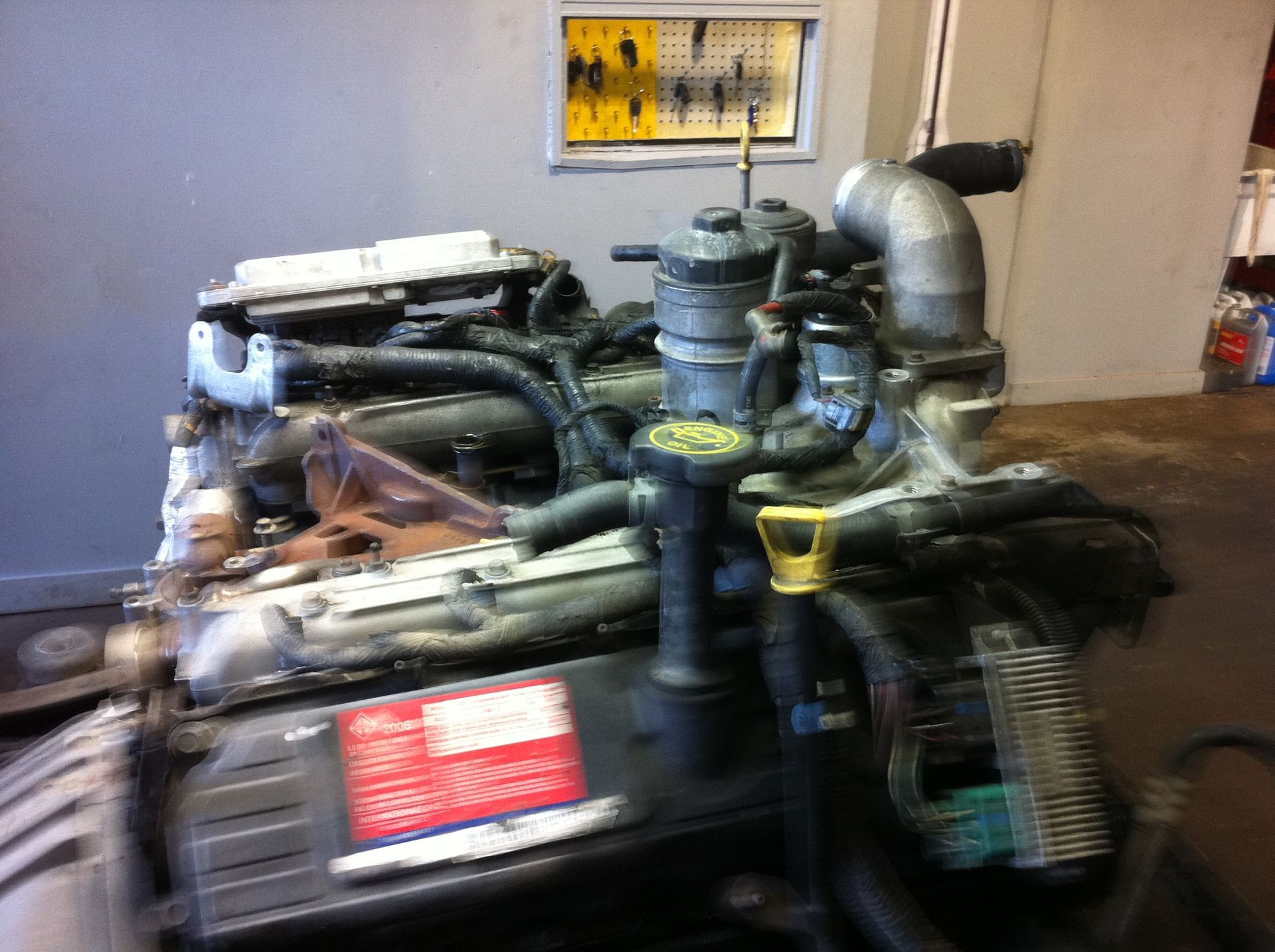 A car engine is sitting on a table in a garage