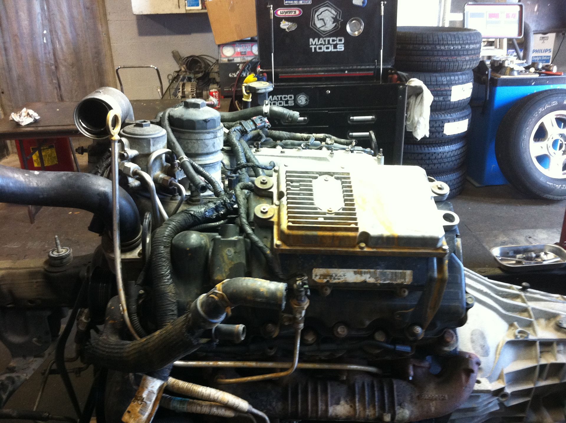 A diesel engine is being worked on in a garage