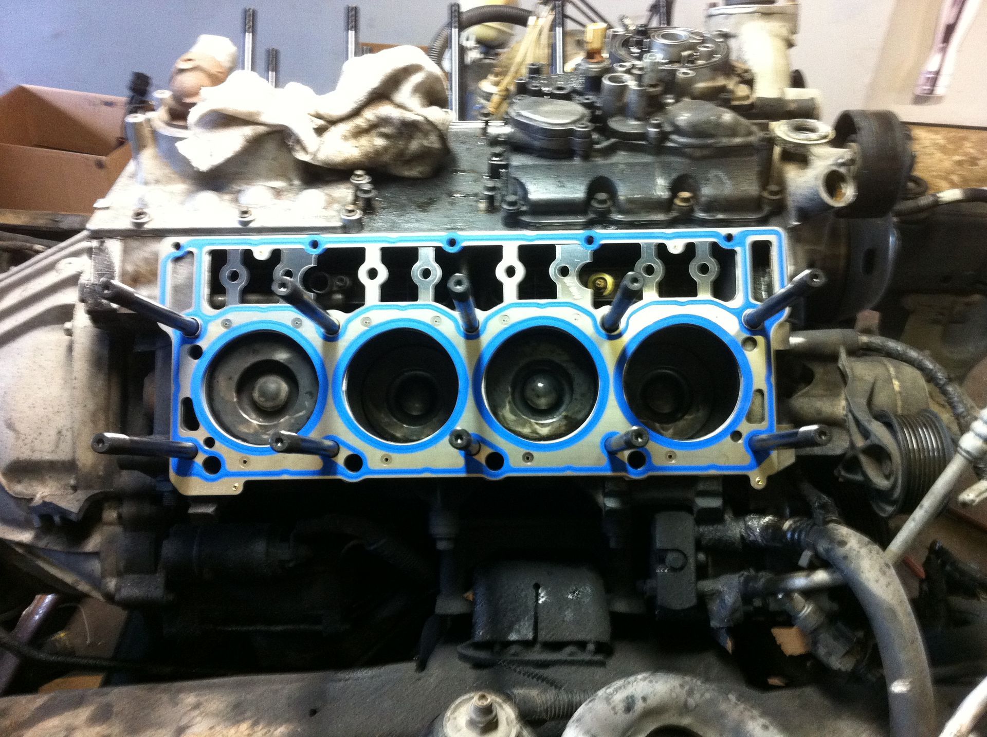 A close up of a car engine with a blue gasket