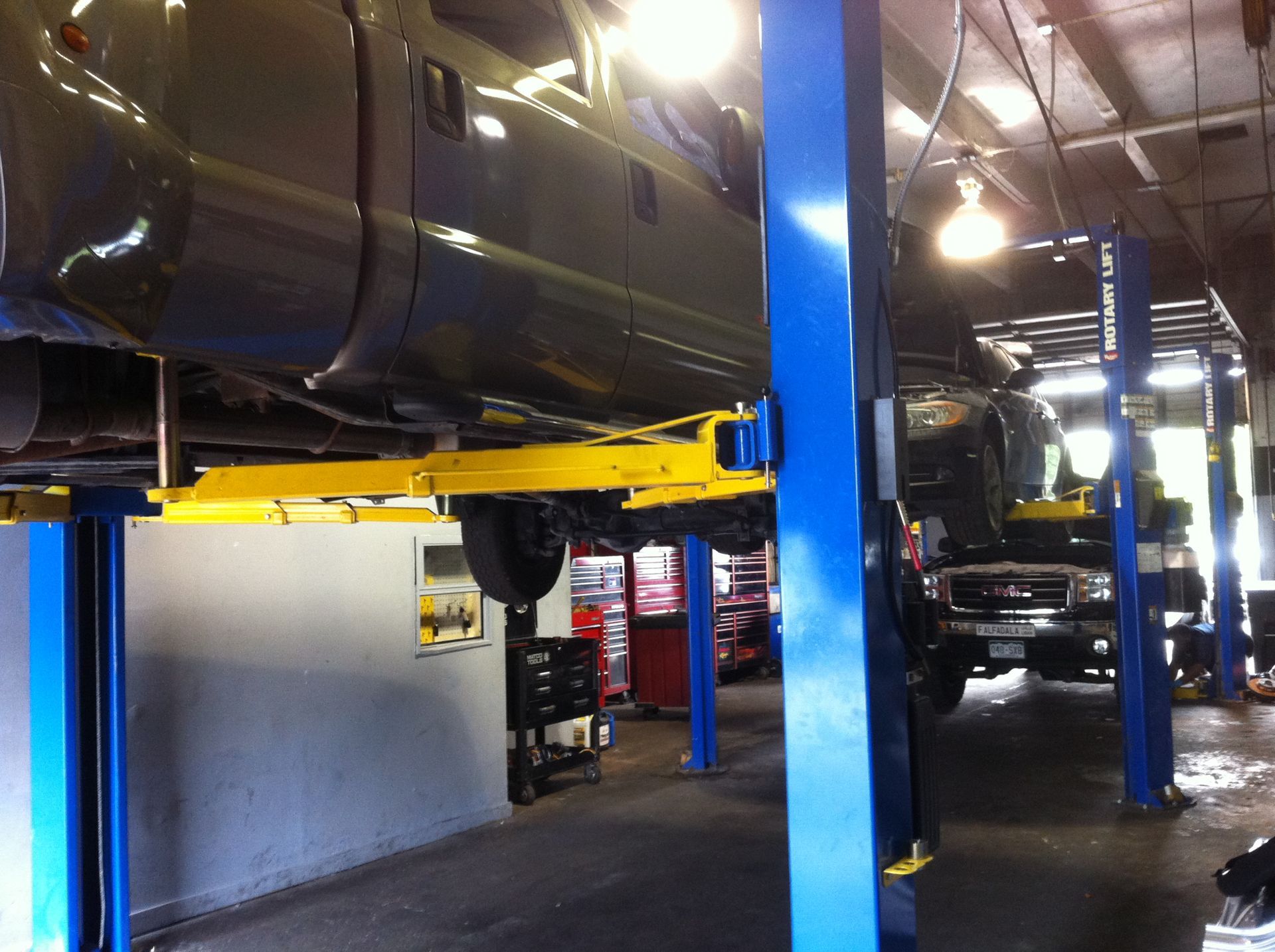 A truck is on a lift in a garage