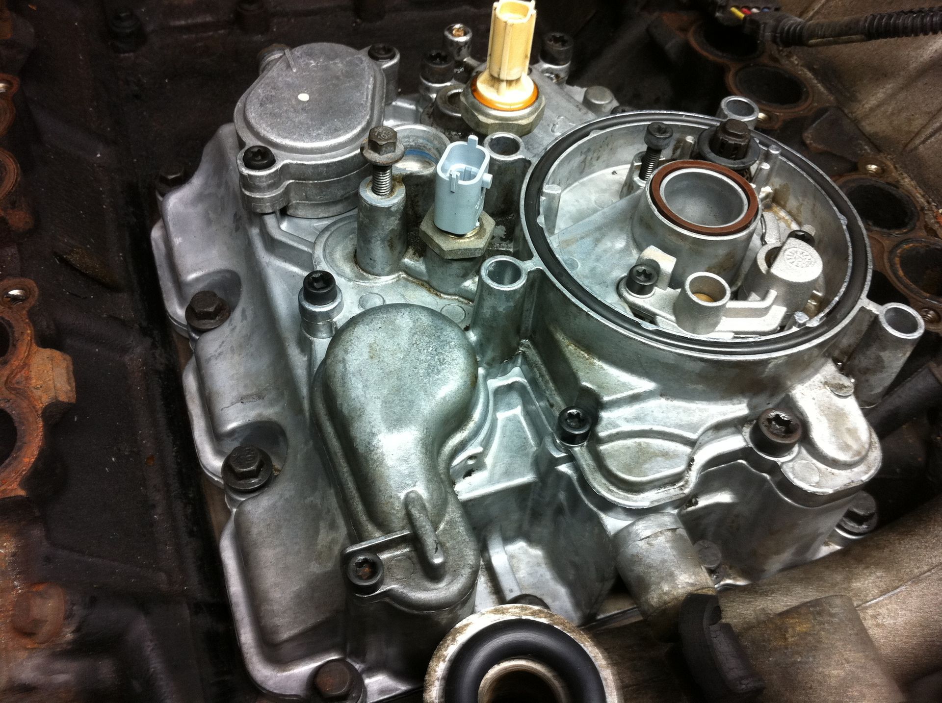 A close up of a carburetor on a car engine.