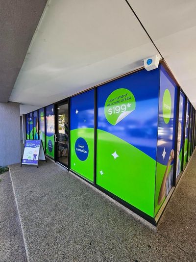 A Building With a Lot of Windows and a Sign on the Side of It — Signworld In Mitchell, ACT