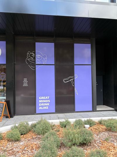 A building with a sign that says great minds drink alone — Signworld In Mitchell, ACT