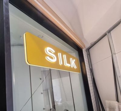 A yellow sign that says silk on it — Signworld In Mitchell, ACT