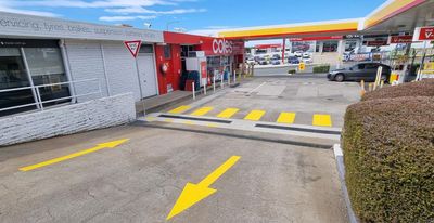 A gas station with a yellow arrow pointing to the right — Signworld In Mitchell, ACT