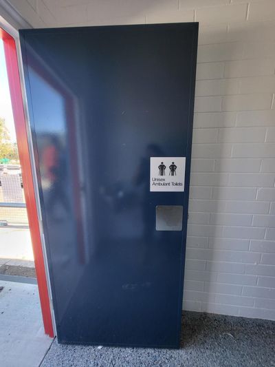 A Blue Door With a Handicap Sign on It — Signworld In Mitchell, ACT