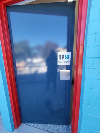 A Blue Door With a Sign on It That Says Toilets — Signworld In Mitchell, ACT