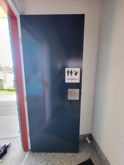 A Blue Door With a Sign on It — Signworld In Mitchell, ACT